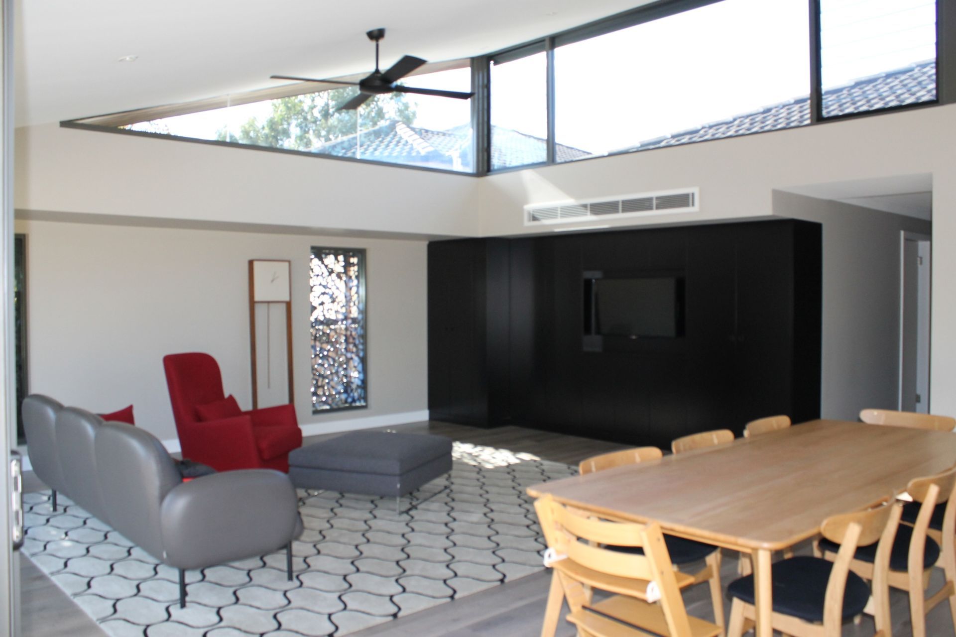 Living and dining area with high level glazing