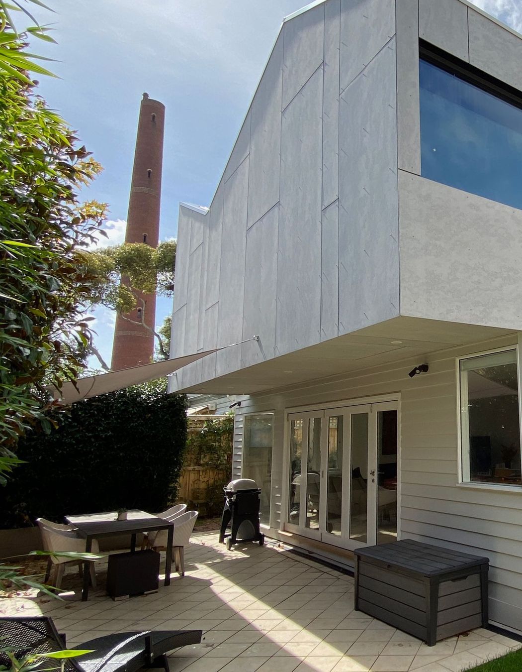Upper storey extension is clad in unpainted fibre cement sheet
