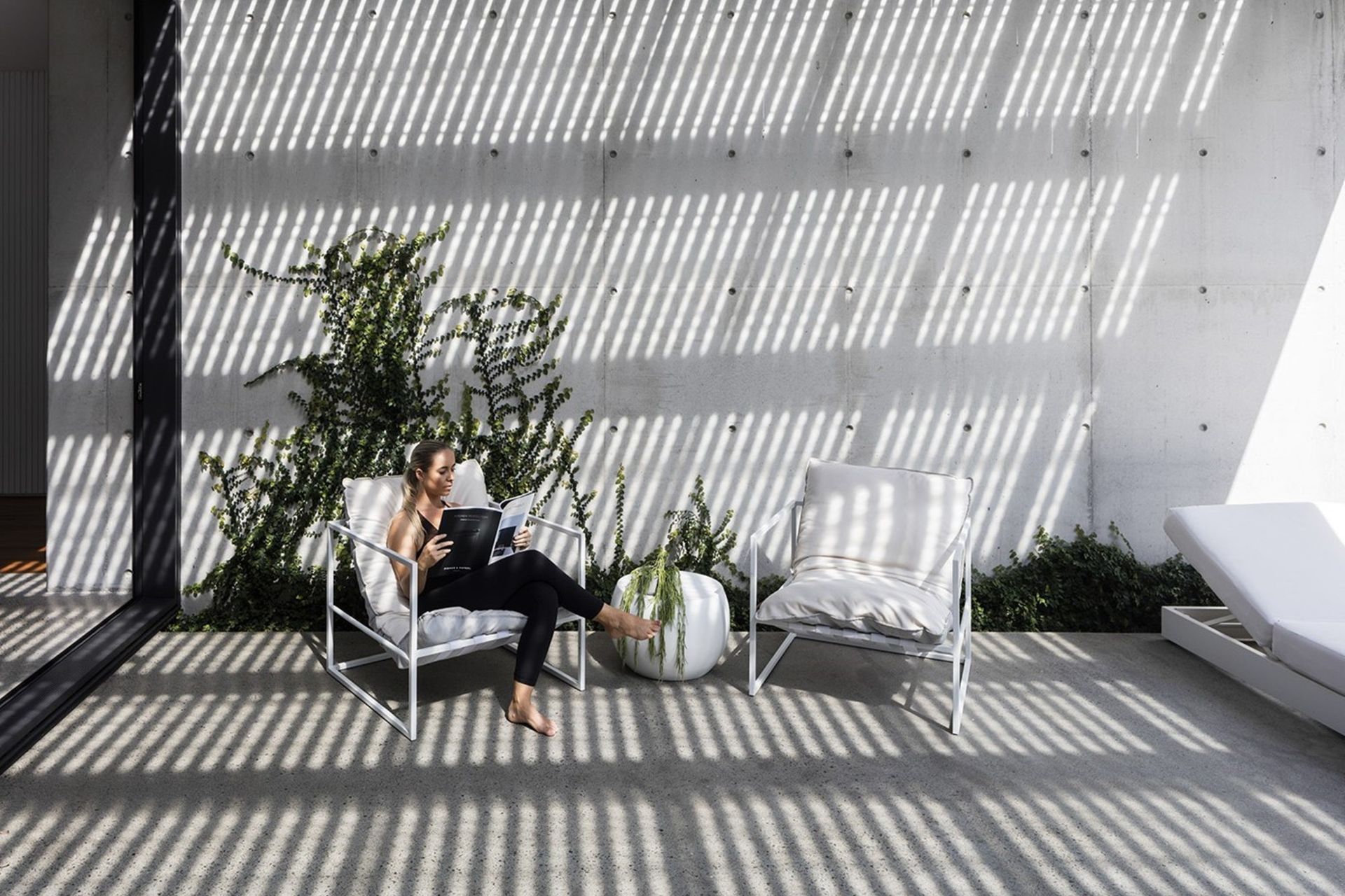 Morrison Residence - Patio. Battened pergola casting striped shadows over the outdoor lounge.