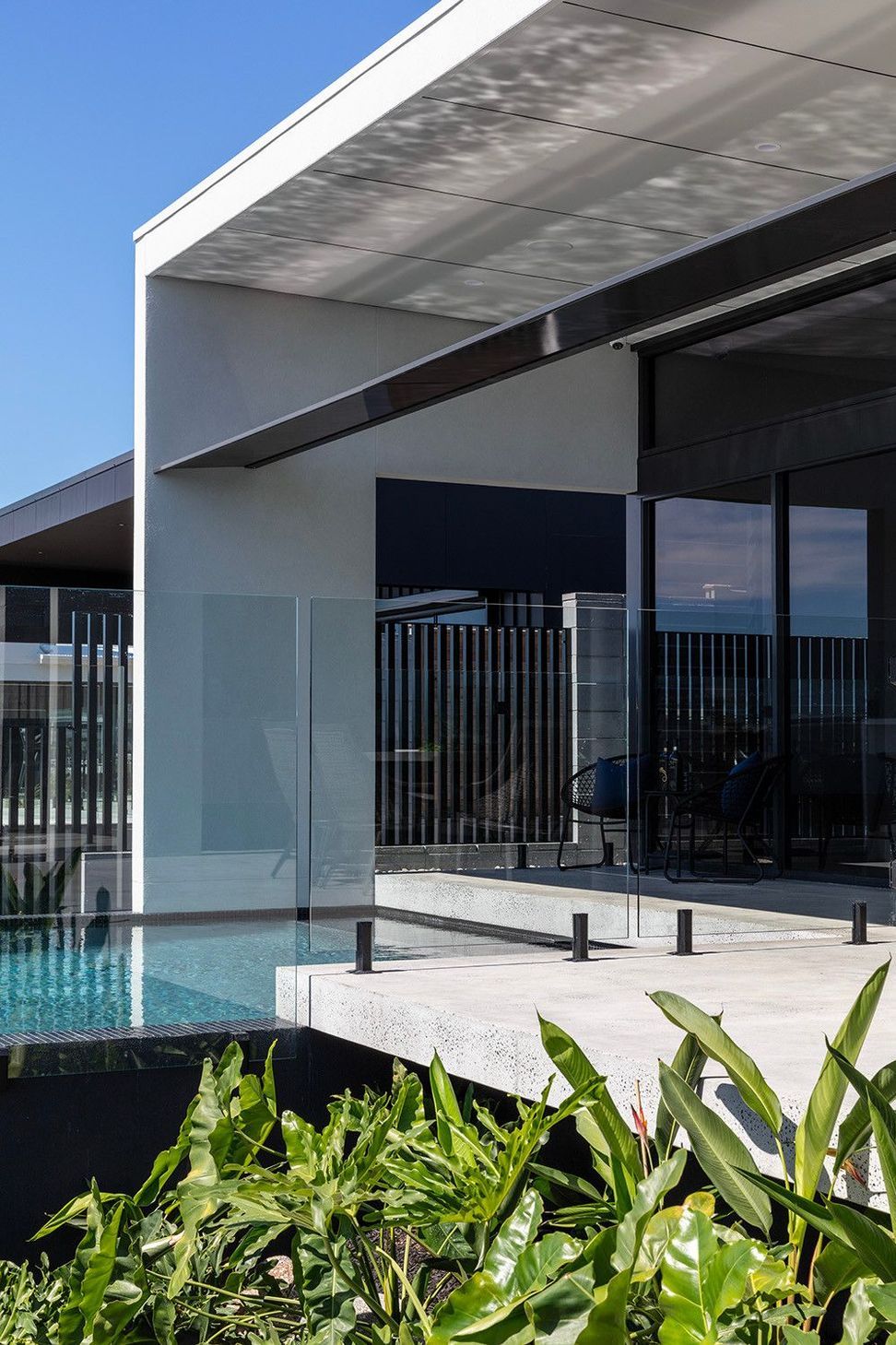 Bells Esplanade - Exterior. Glazed sliding doors and balustrade at dusk.