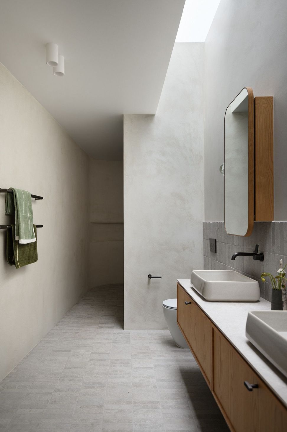 Villa Solare - Bathroom. Concrete walls and a timber vanity in the ensuite.