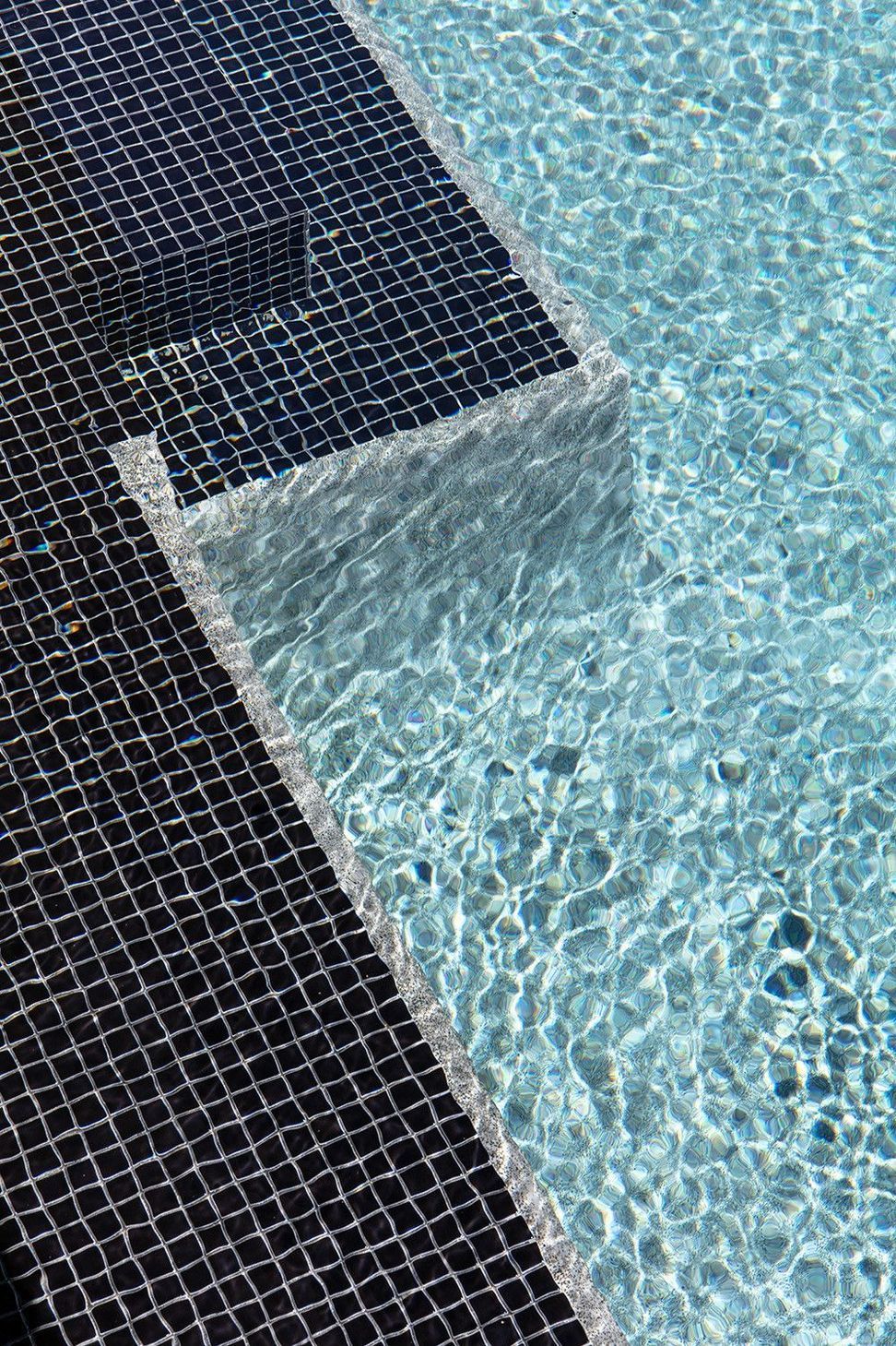 Bells Esplanade - Pool. Dark mosaic pool tiles and rippling water.