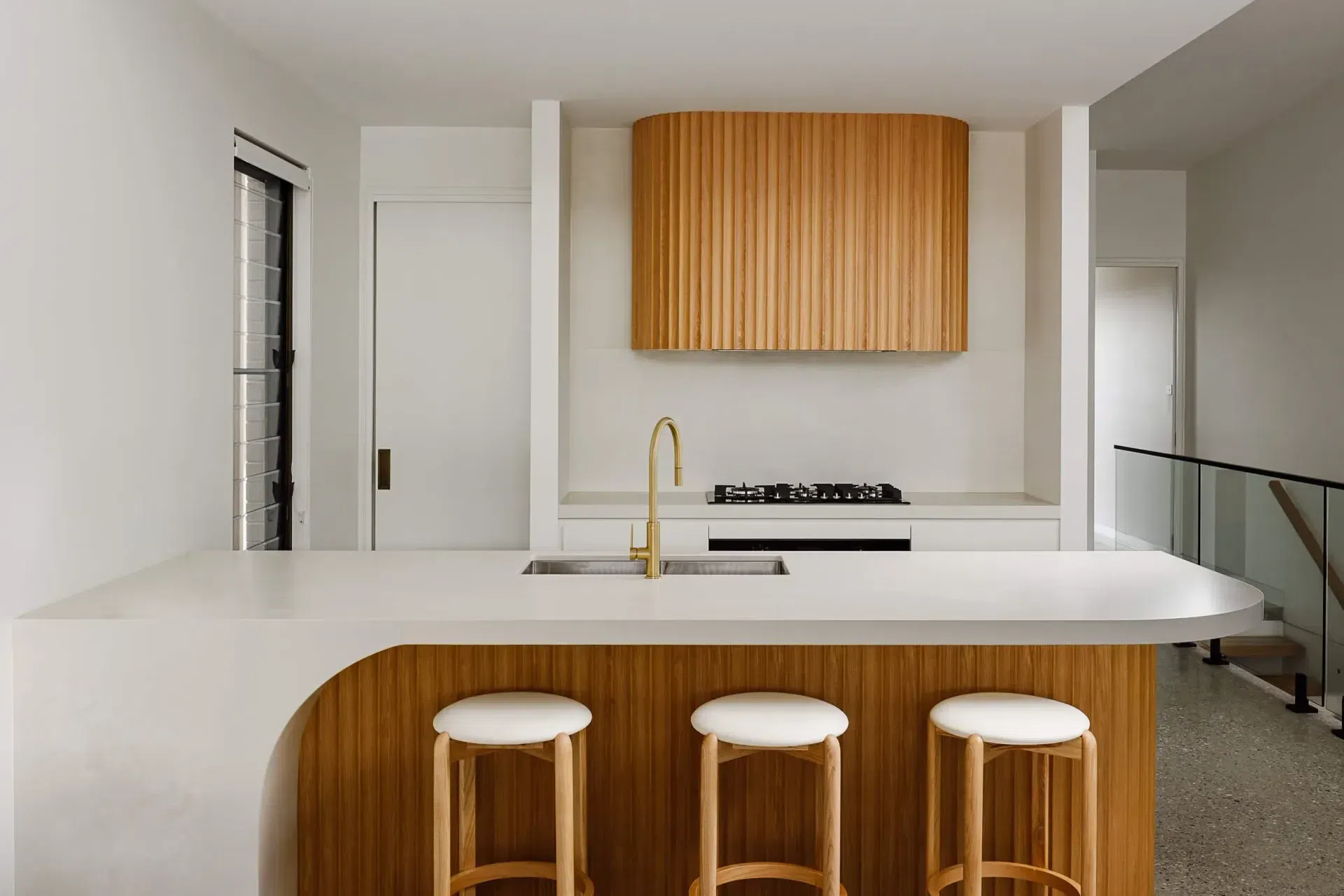 obrien-duplex-bulli-kitchen-fluted-timber-island-brass-tapware-light-and-lines.webp