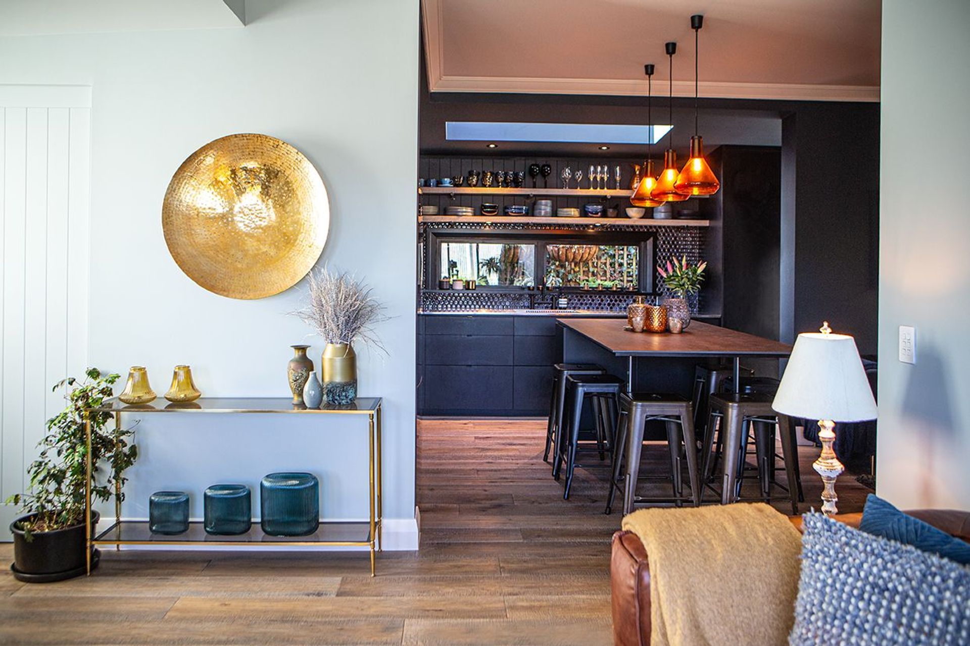 Light meets dark at the entrance to the kitchen design.