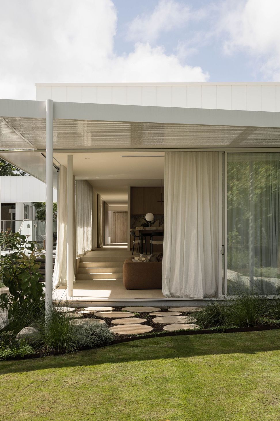 Henderson - Patio. Covered outdoor room with sheer curtains opening to the garden.