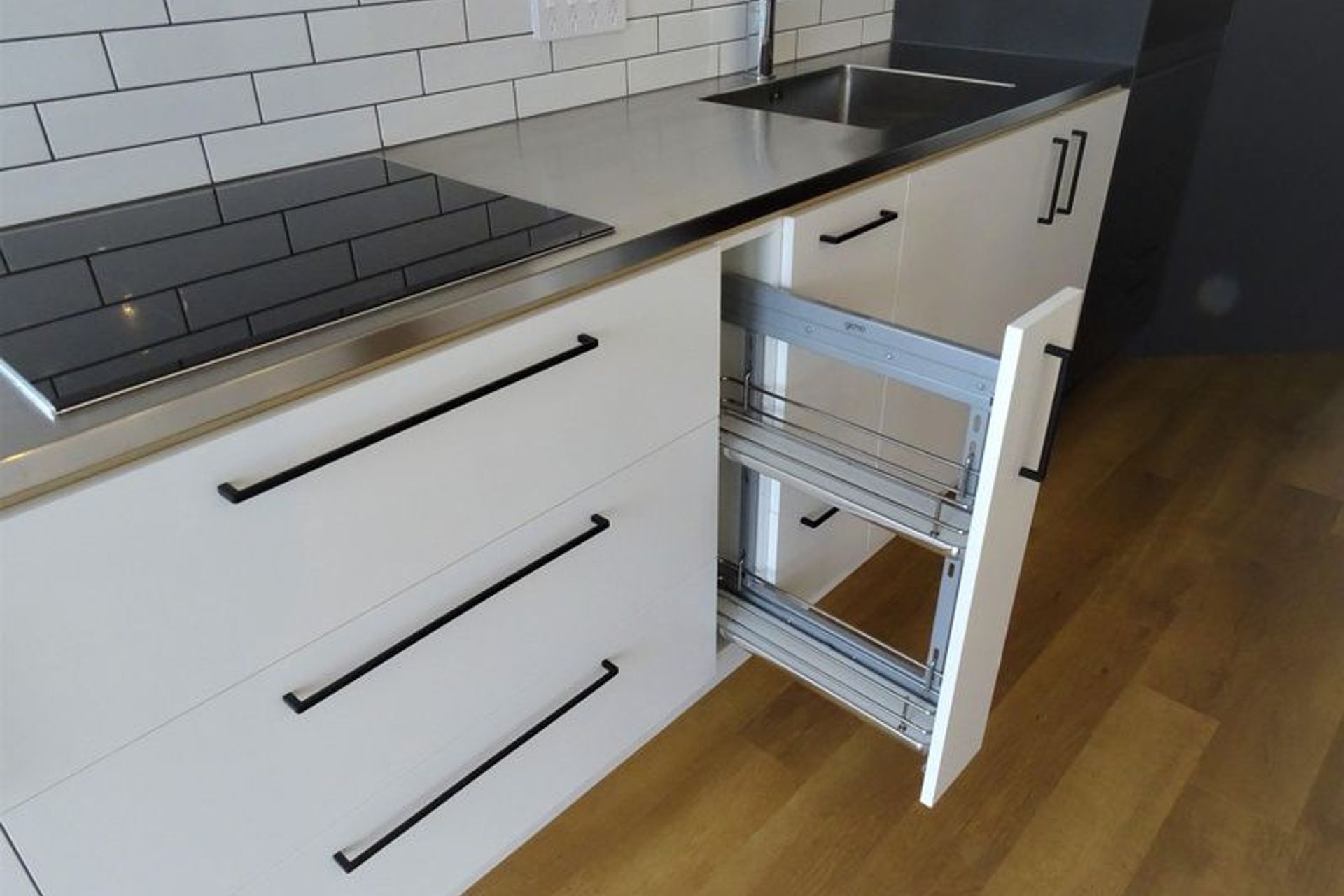 Handy Kitchen storage for spices and sauces right next to the oven