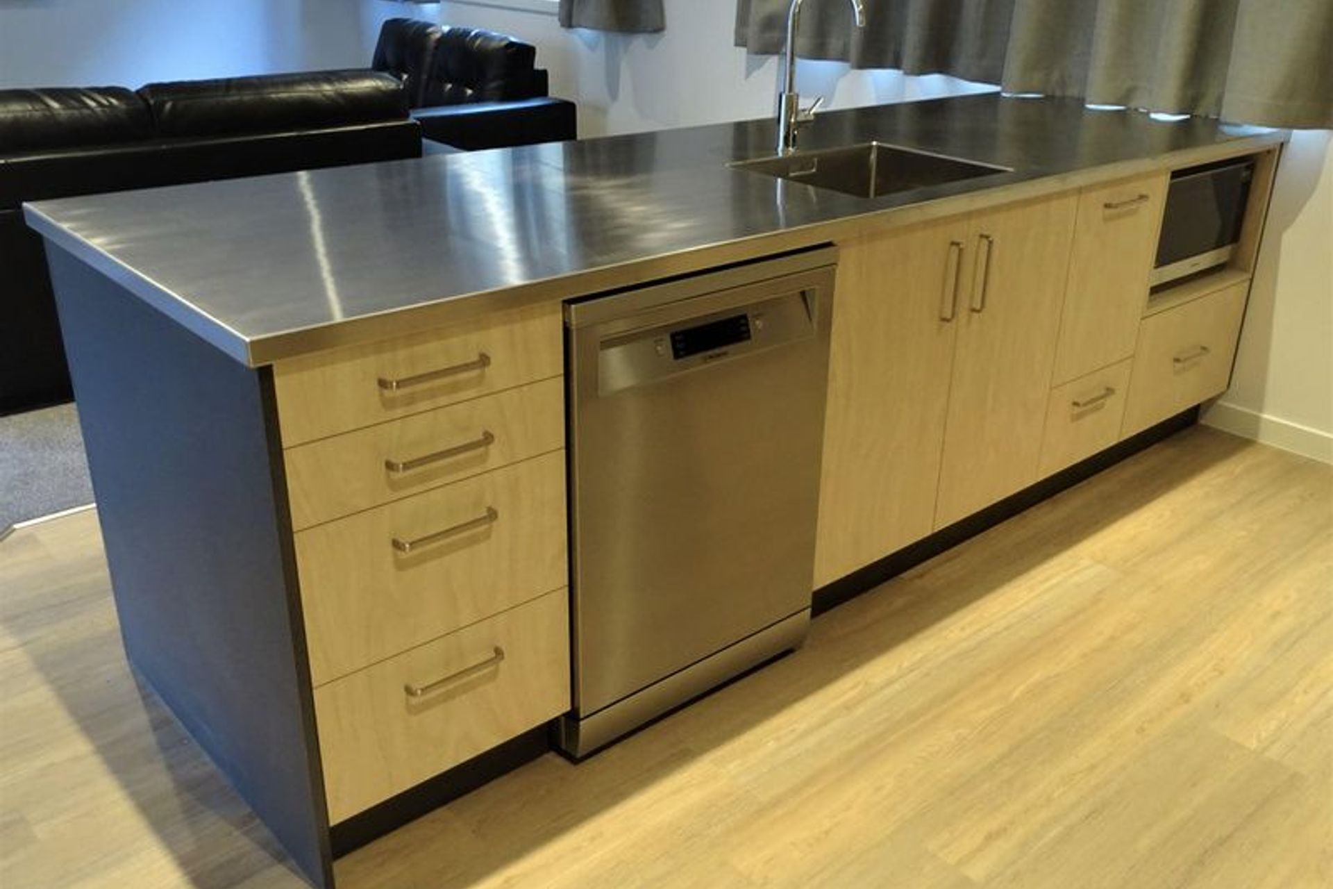 Kitchen cabinetry dishwasher and microwave built into the kitchen island