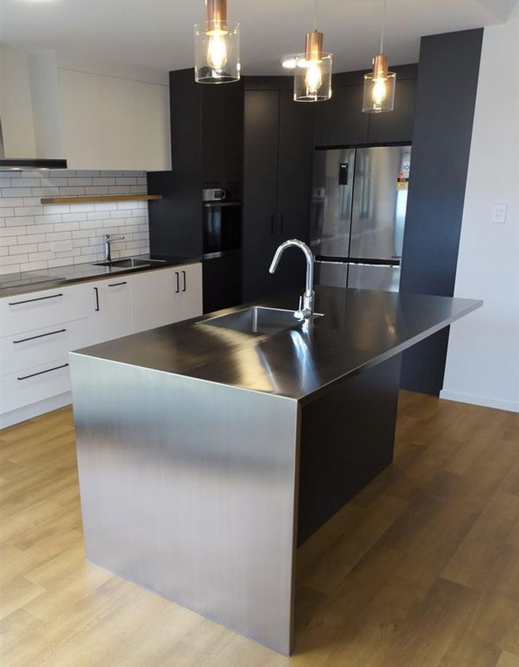 Stainless steel kitchen island with room for breakfast bar seating