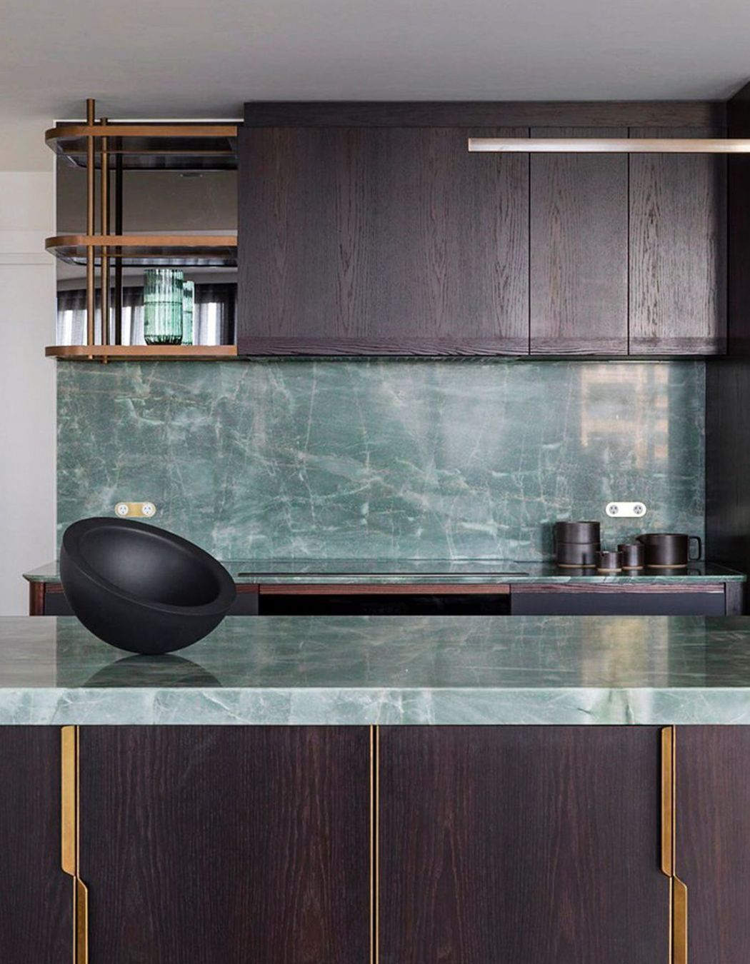 We designed custom brass handles and shelving for the kitchen.
