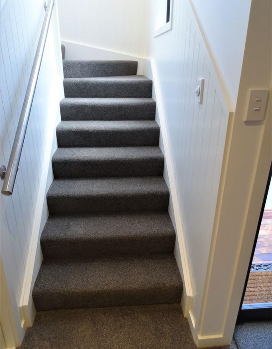 The stairs curve at the top and have wall detailing