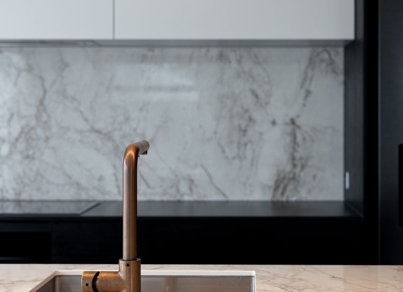 A Contemporary Black Kitchen Features Dekton Bergen