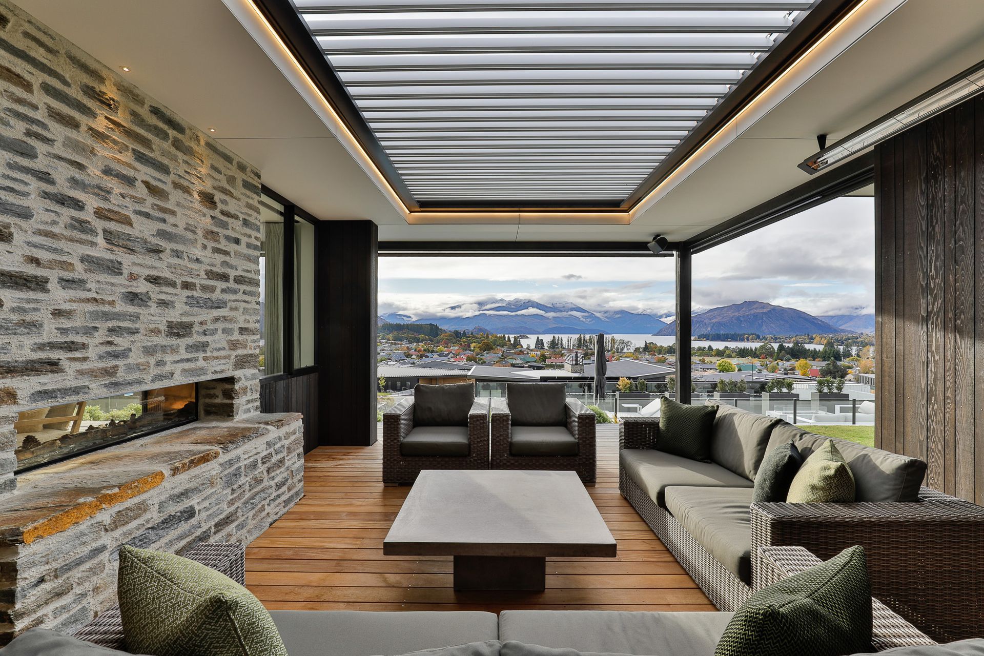 Outdoor Living Room with louvres overhead and ceiling mounted directional heaters. Interior Design- Kelly @ Archi Build Ltd.