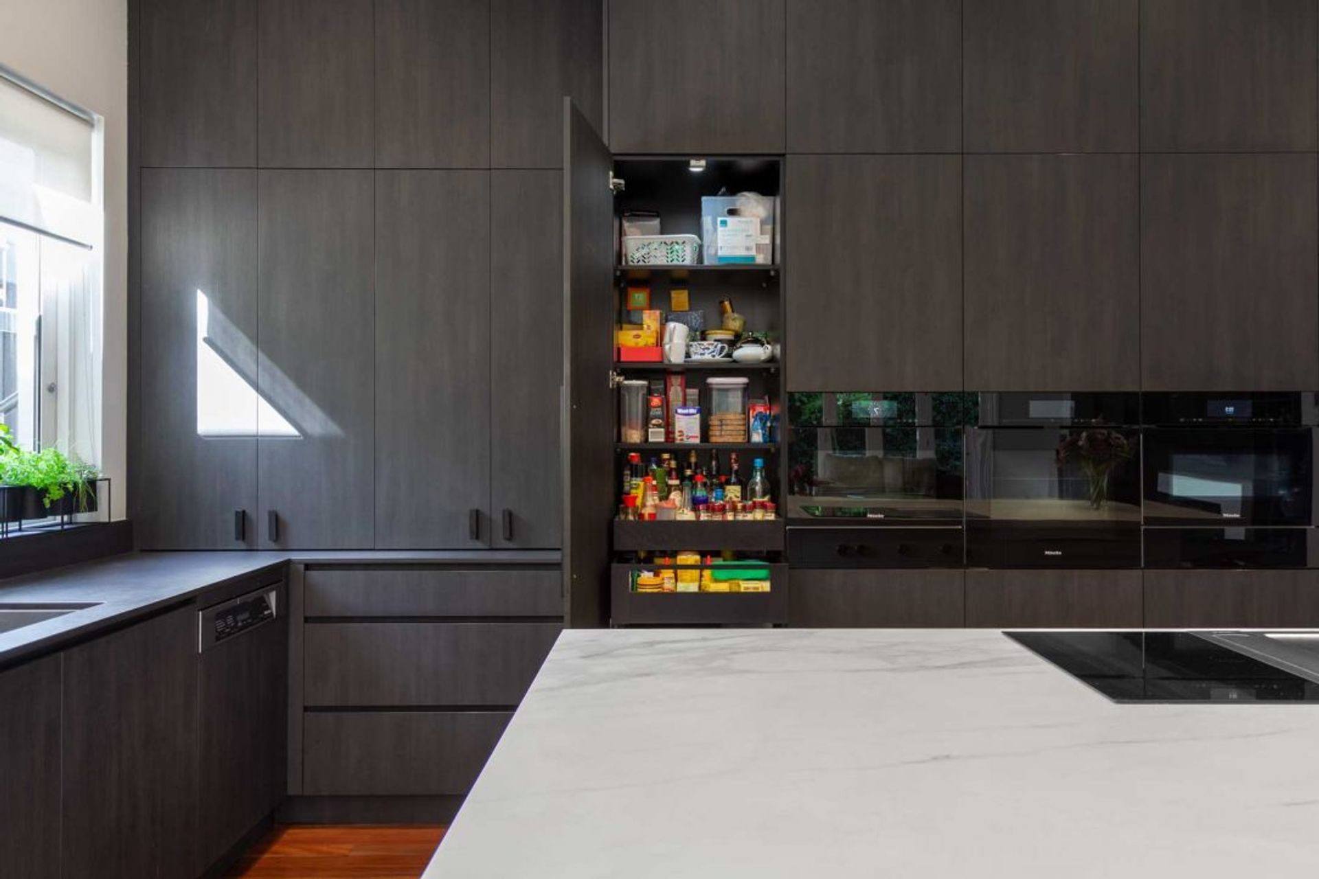 premier-kitchen-design-sydney-neolith-dekton-benchtop-splashback-dark-timber-white-pantry-1084x723.jpg