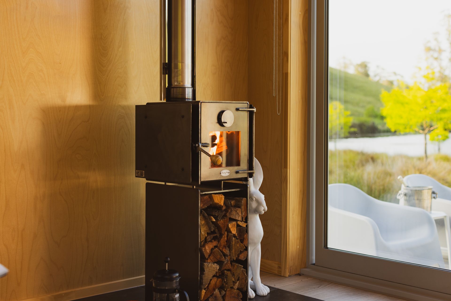 Cosy birch plywood interior with Roaring Meg fireplace