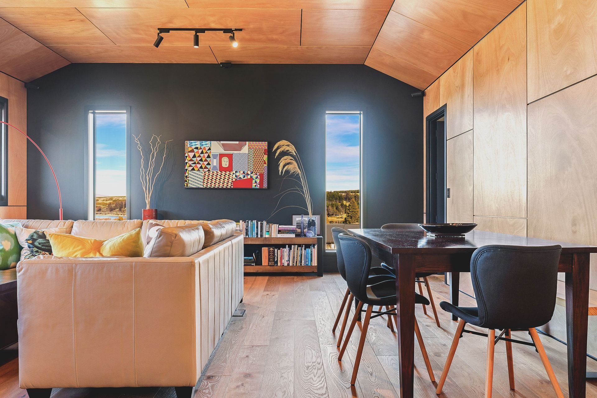 Homeowners planned the footprint around furniture they already owned, including the dining table and a sofa from Gascoigne Furniture which has been decorated with a huia scatter cushion from Spotlight.