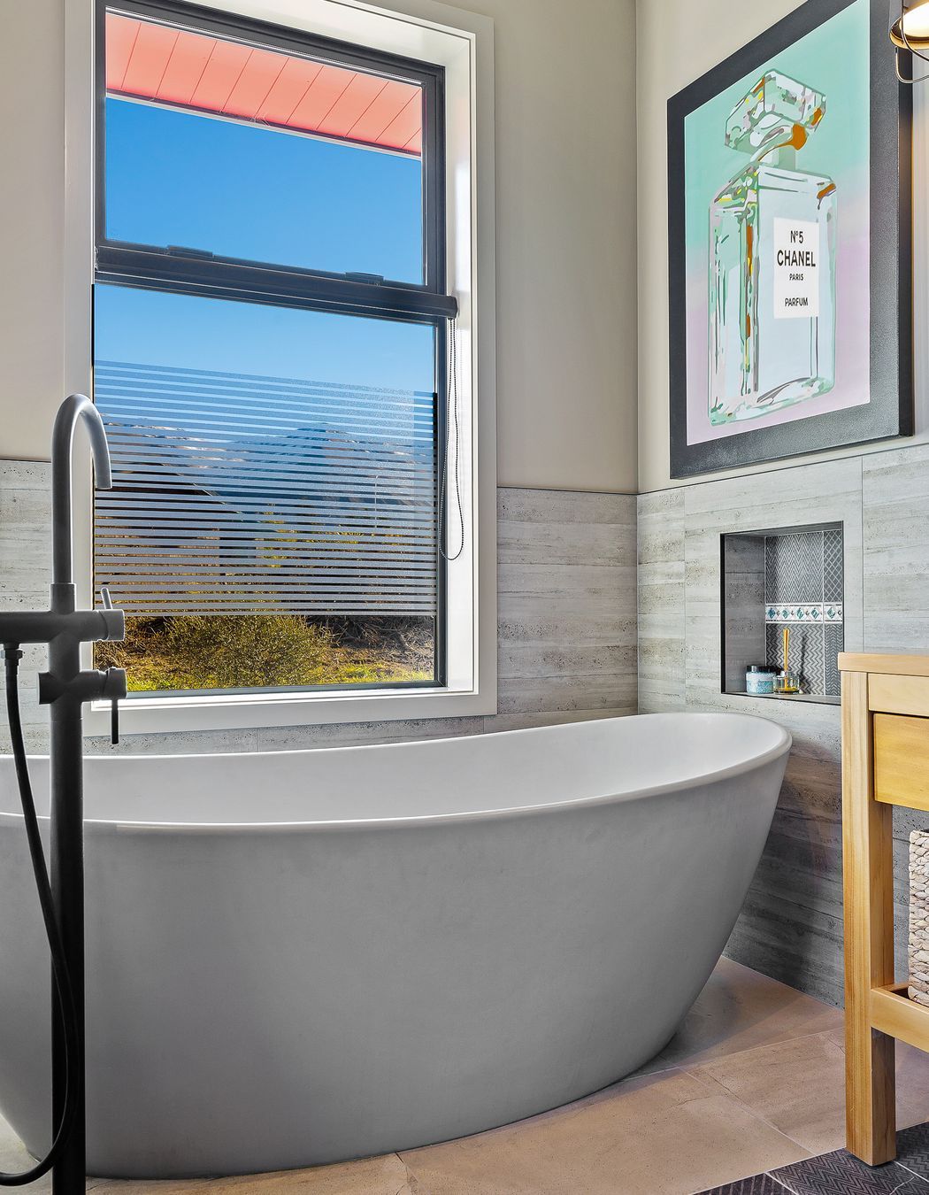 A luxurious Vivienne bathtub with organic lines was a must for long soaks in the middle of winter. Sandstone Grey Matt floor tiles and Casero Grey wall tiles continue the textural theme.