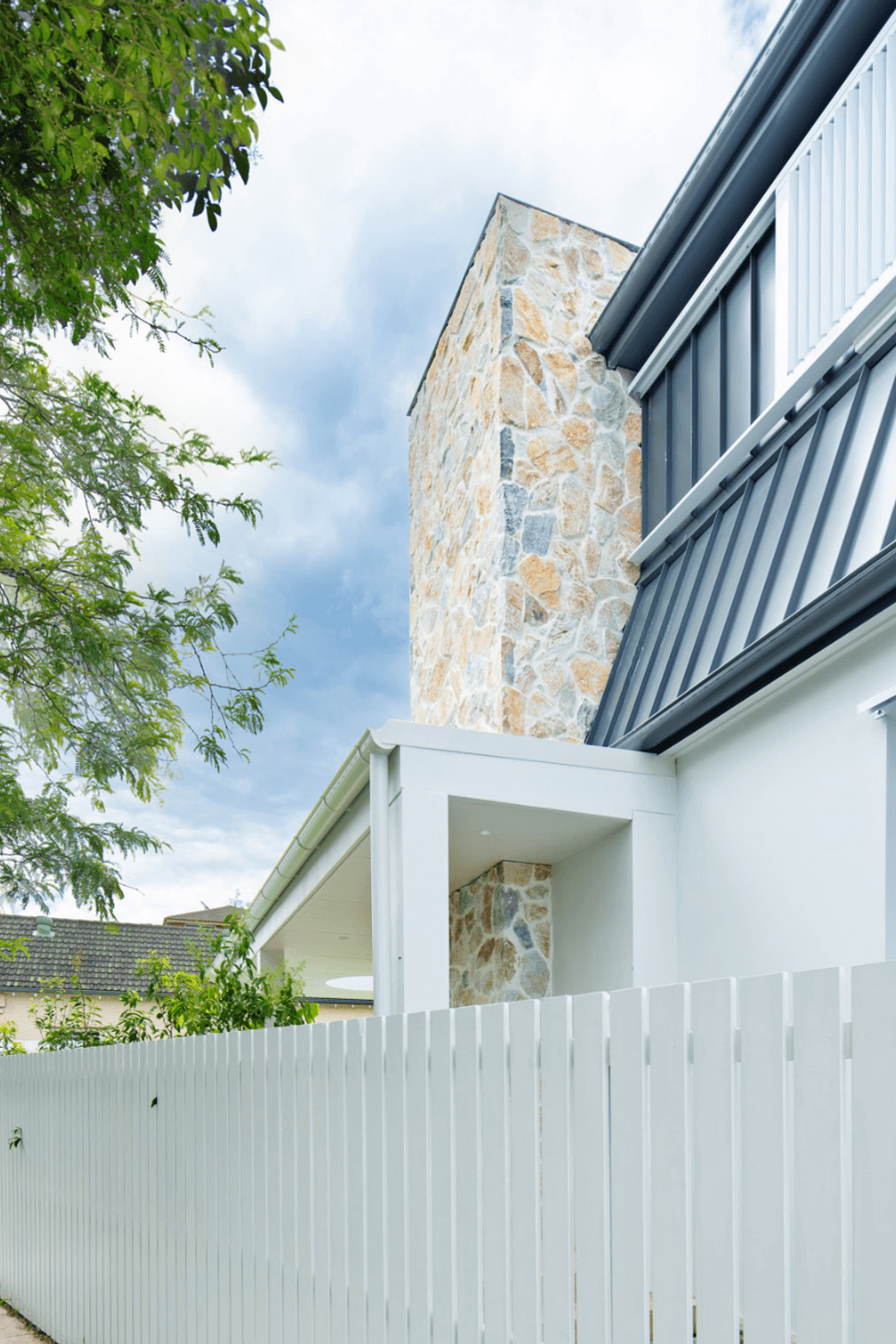 Summit wall cladding on the chimney exterior. Raw texture against crisp white render.