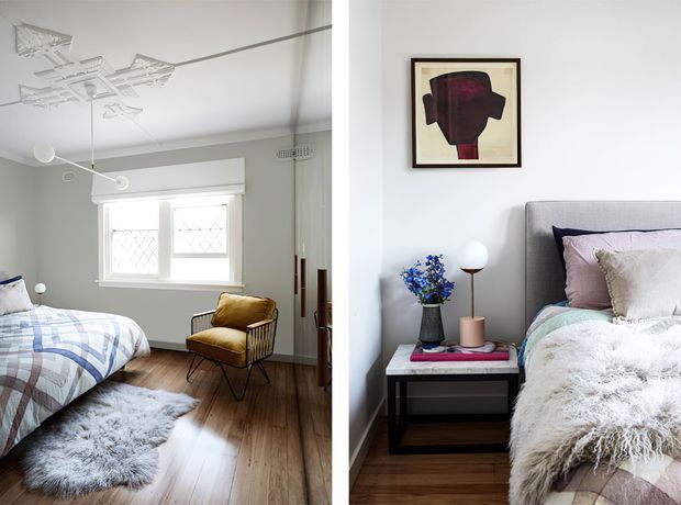 Split view of a styled bedroom featuring two perspectives: a bed with blue-and-white checked bedding, a mustard upholstered accent chair, white walls, timber flooring, a shag rug, and decorative ceiling detailing on the left; and a second bed with layered neutral and mauve bedding, a dark upholstered headboard, bedside table, artwork, lamp, and flowers on the right. The room has a bright, refined, eclectic character.