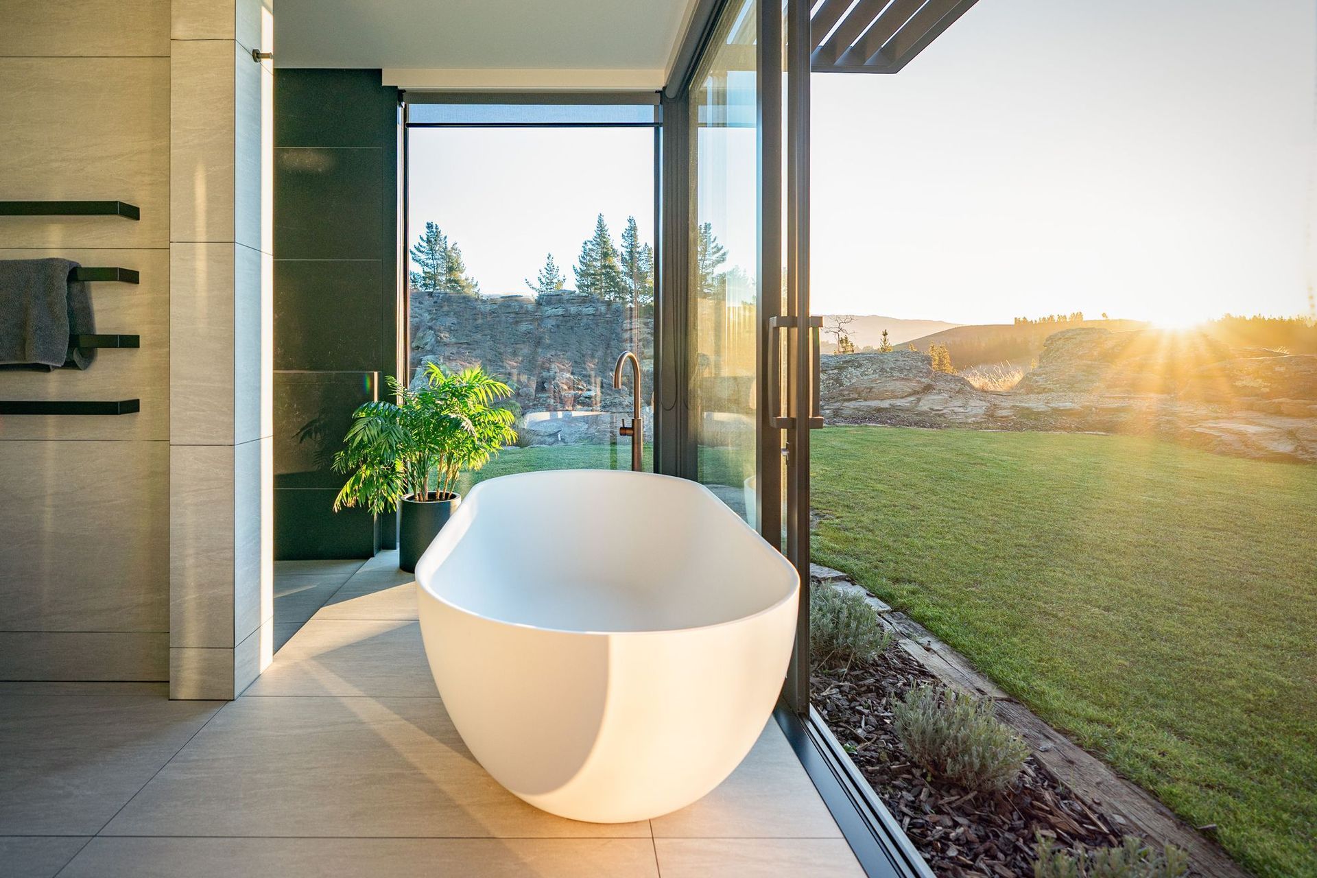 Peeling back the sliding doors in the master en suite, you can bathe in plein air.