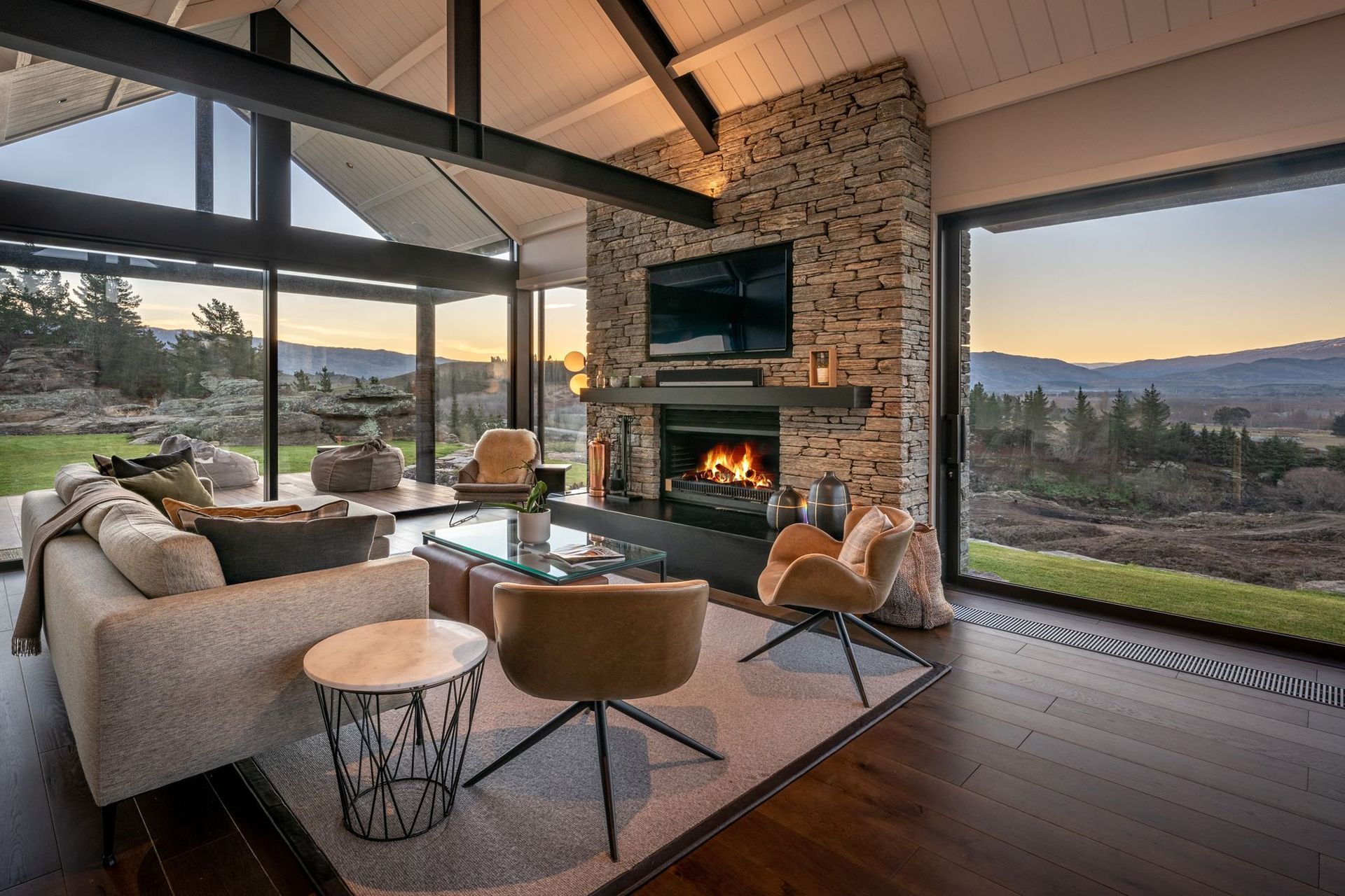 In front of the schist fireplace in the lounge is the perfect spot to relax in the evening and watch the sun set across the valley.