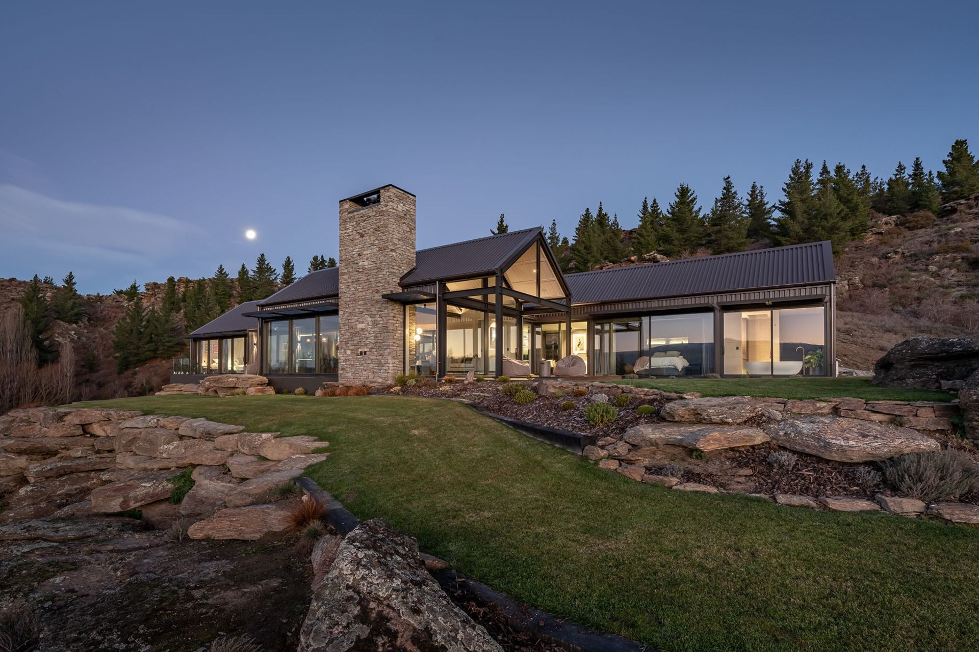 The home, built by CDL Building features three gable forms and schist chimneys.