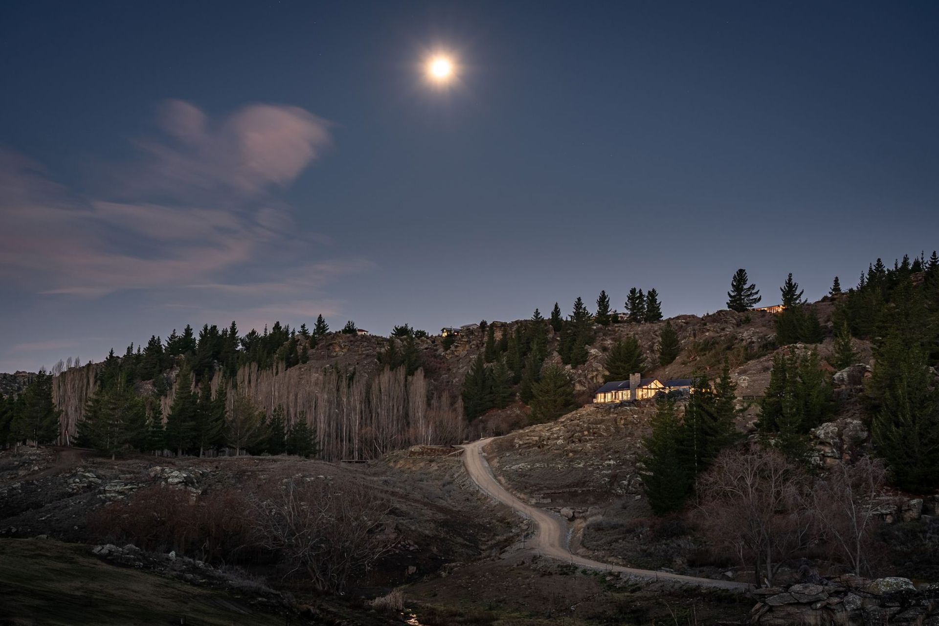 The winding journey from the road below up to the house builds a sense of suspense.