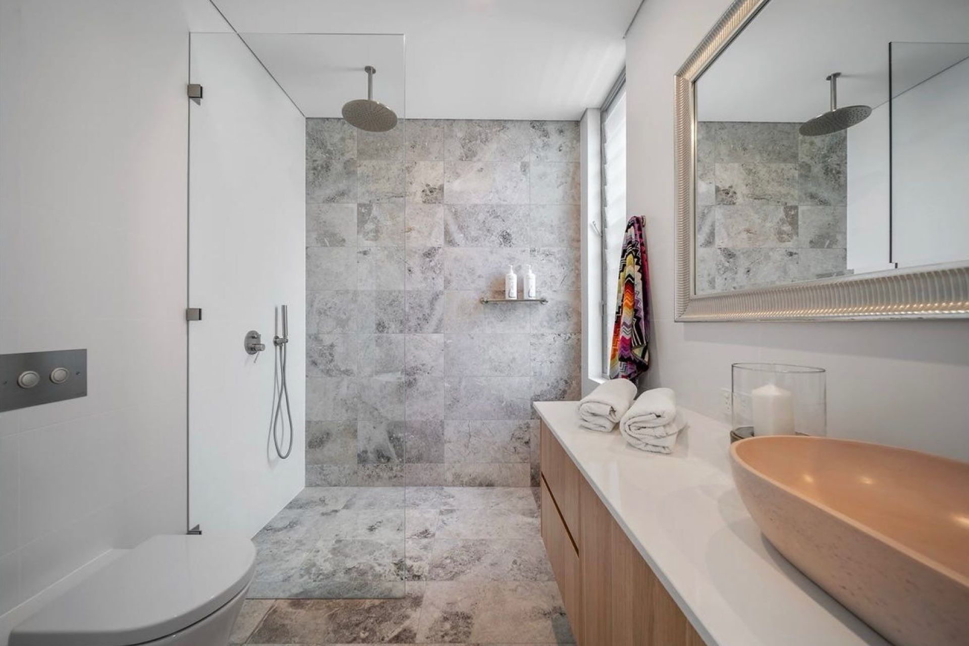 One of the three quality bathrooms in the home. Luxury appointments throughout, finishes allow for ease of maintenance for all those sandy showers