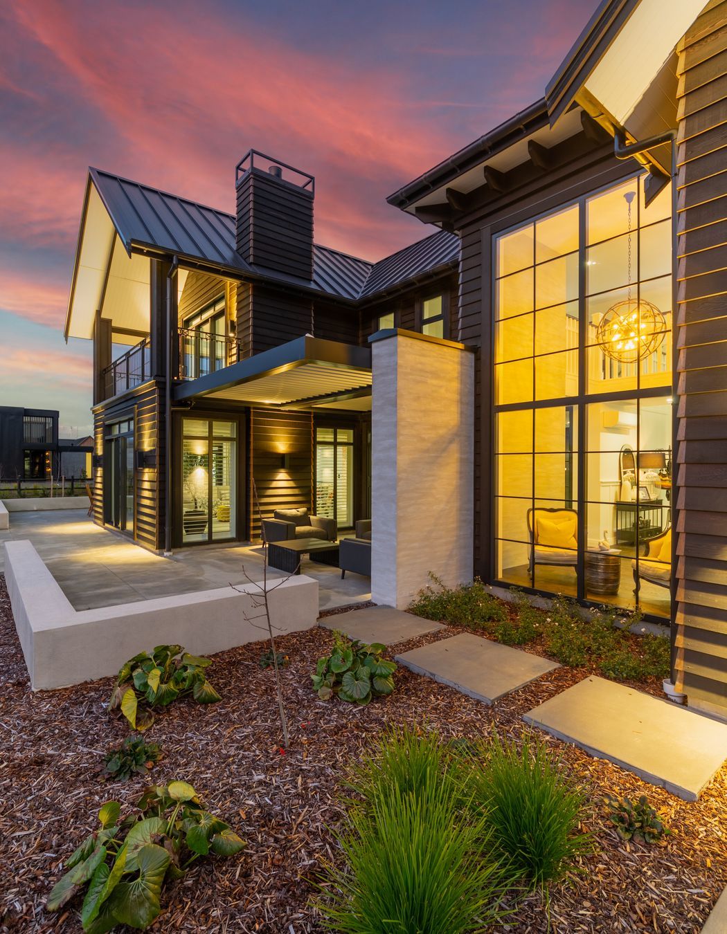 In this image you can see the interaction of all of the different building elements, from the foyer's double-height glazing, to the louvred outdoor courtyard and the gabled roofs with corbel details under the soffits.