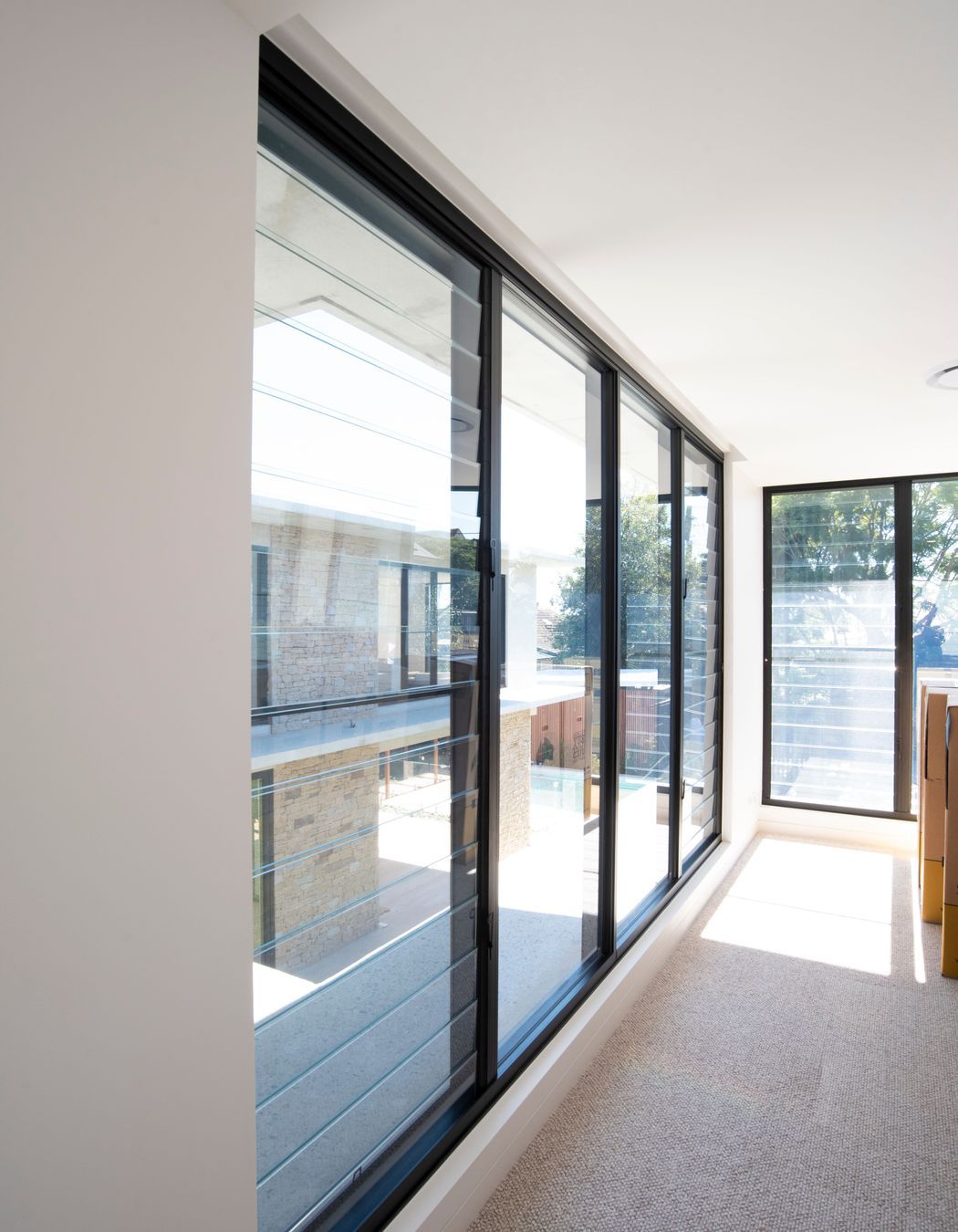 Eye-catching vistas of the backyard are opened up by the EzyPelmet recessed pelmet system installed alongside EzyReveal windows