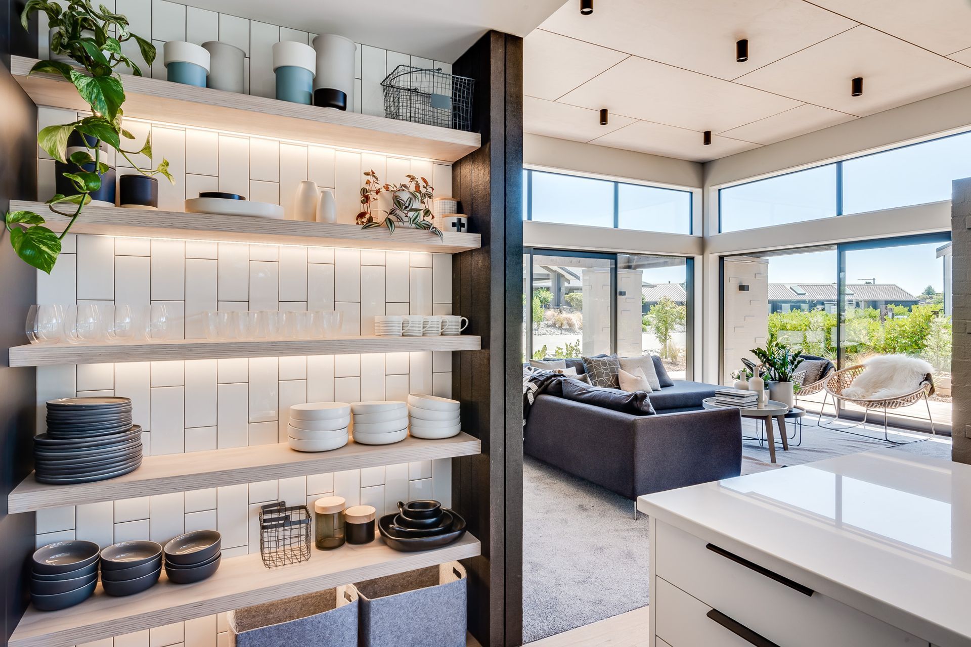 The tile splashback has a vertical layout, a motif that has been repeated throughout the home.