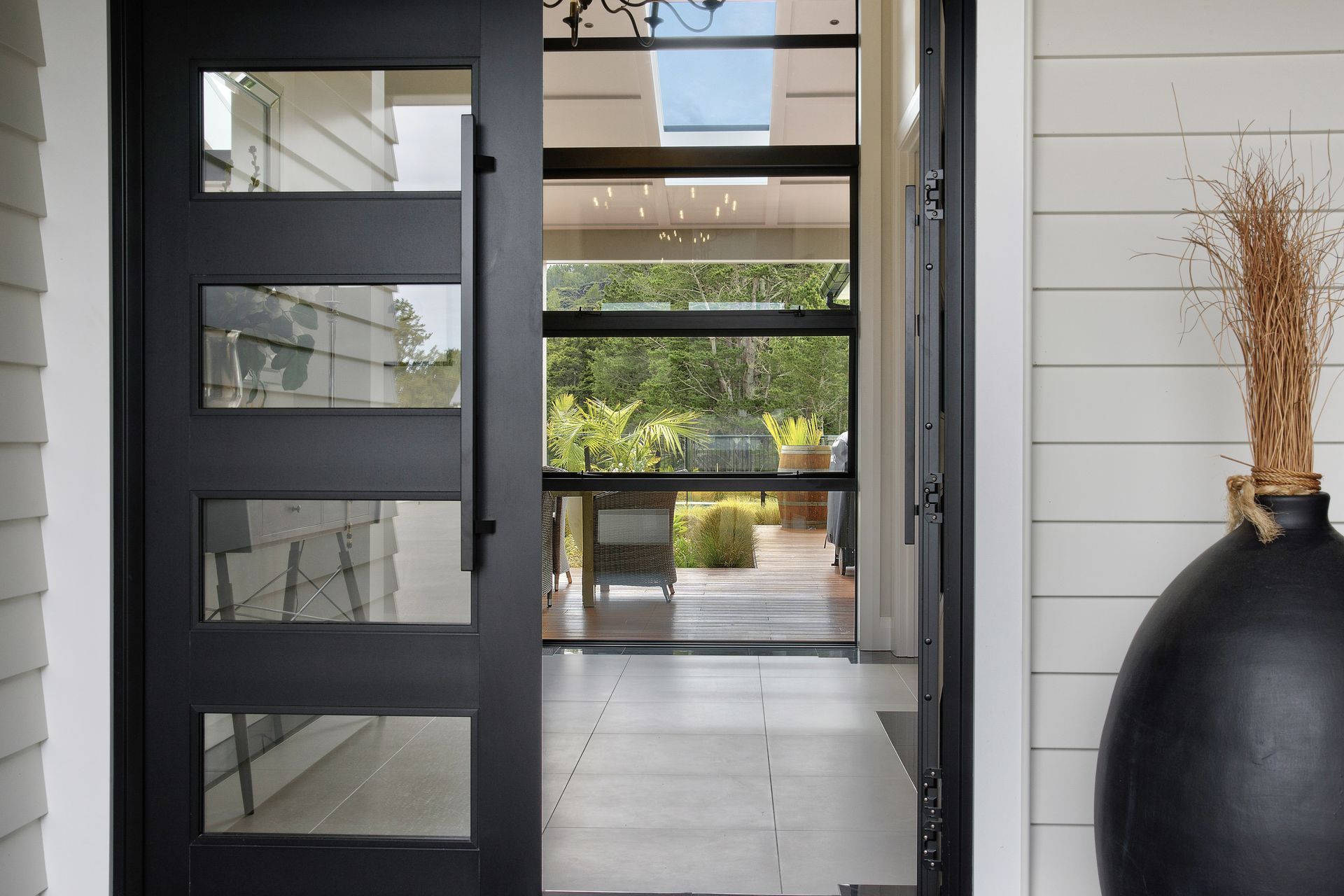 The glass front door and glass panels in the hallway allow the bush views to meet the visitors eye, before stepping into the house.