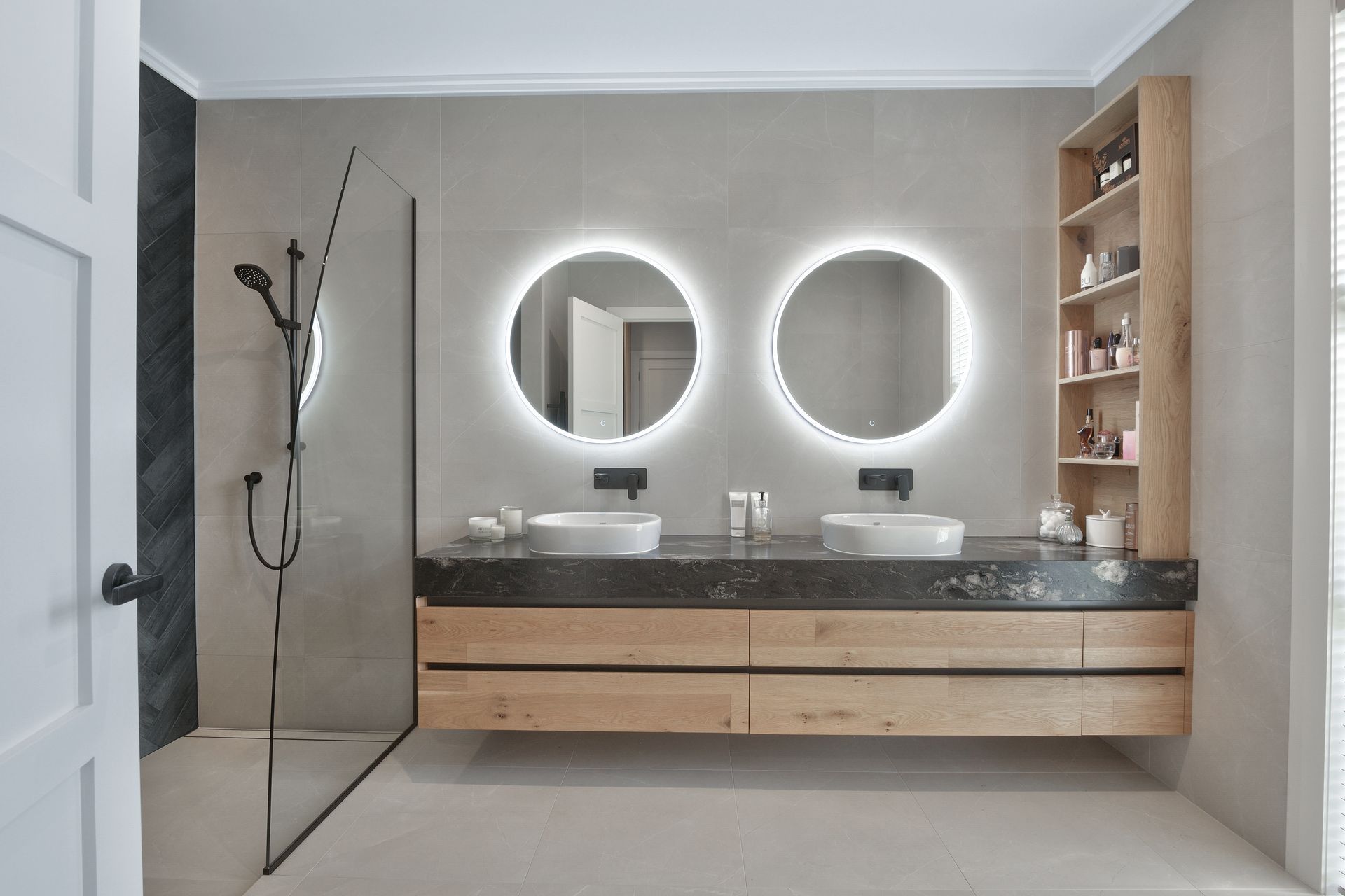 The master en suite features a luxurious double vanity and fully tiled surfaces.
