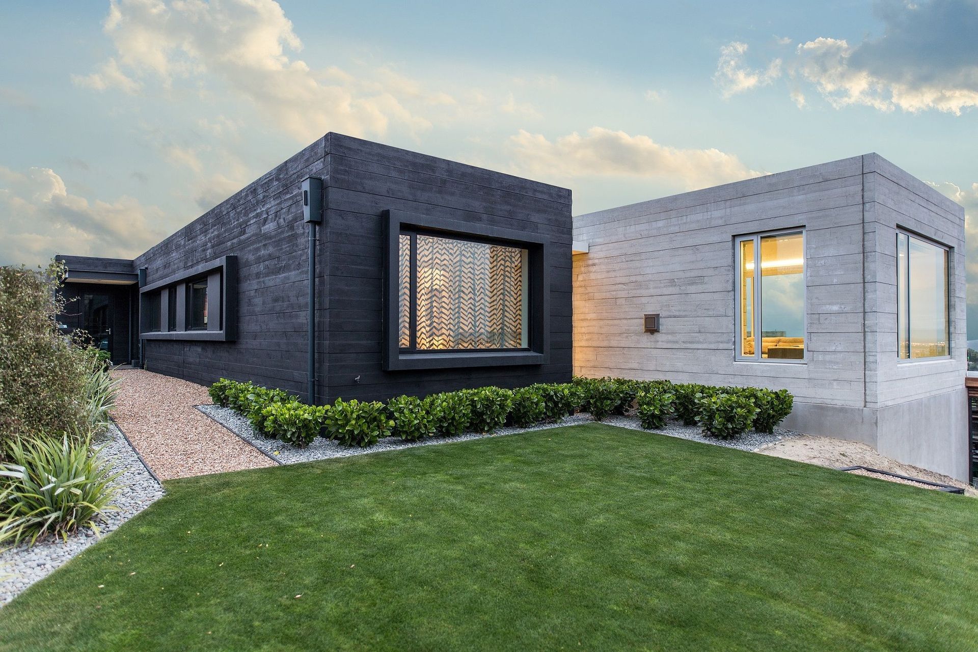 A black, timber stain was used on the exterior of the 'private' pavilion to provide contrast with the 'public' one. Similarly, an expressed window treatment on the one balances the recessed treatment of the other.
