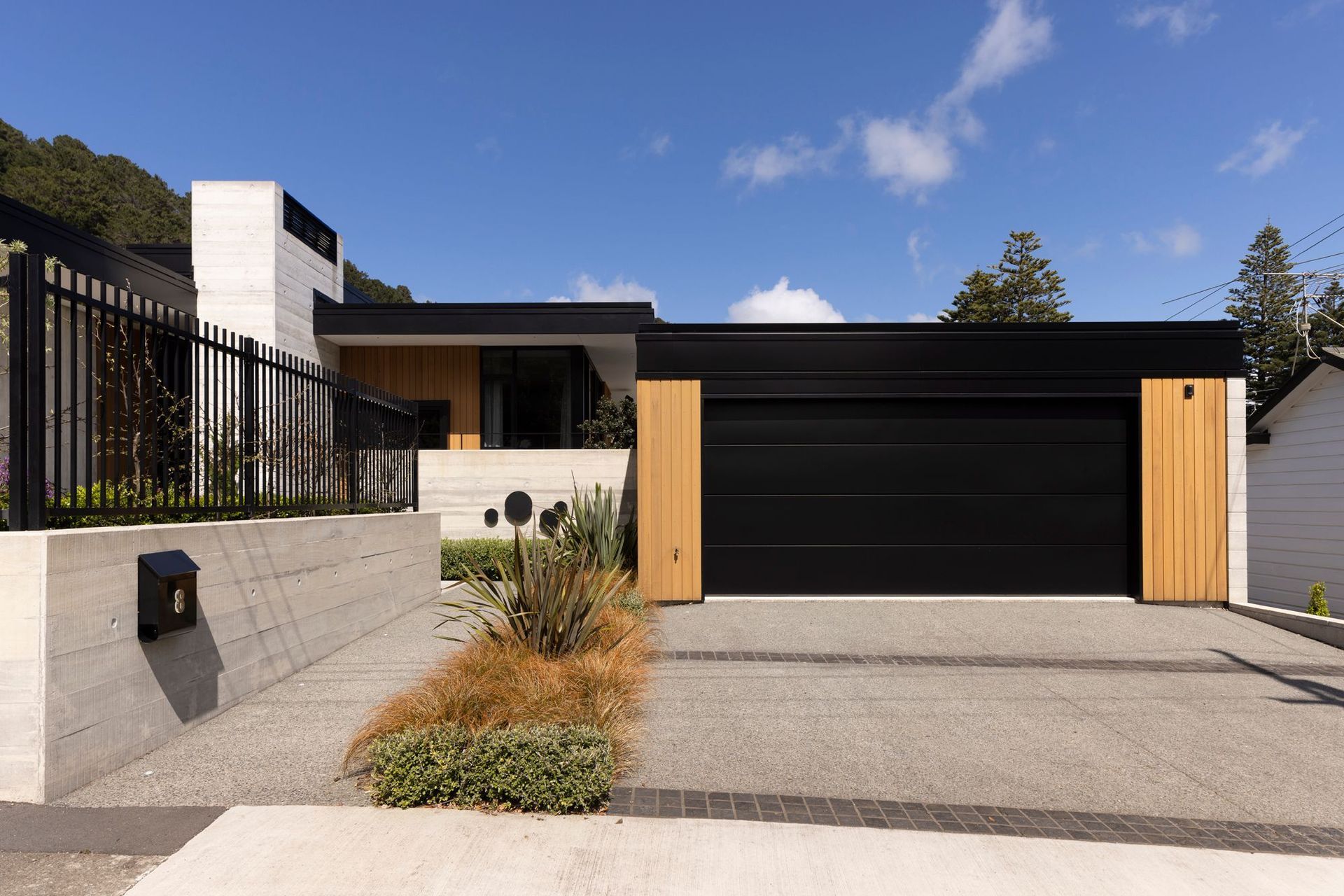 The three-bedroom home in Wellington’s Eastbourne is predominantly formed-concrete and cedar, says Richard Beatson of Studio Pacific Architecture. “The material palette is deliberately limited to maintain clarity in the design. It’s a contemporary interpretation of a mid-century style in scale, form and materiality.”