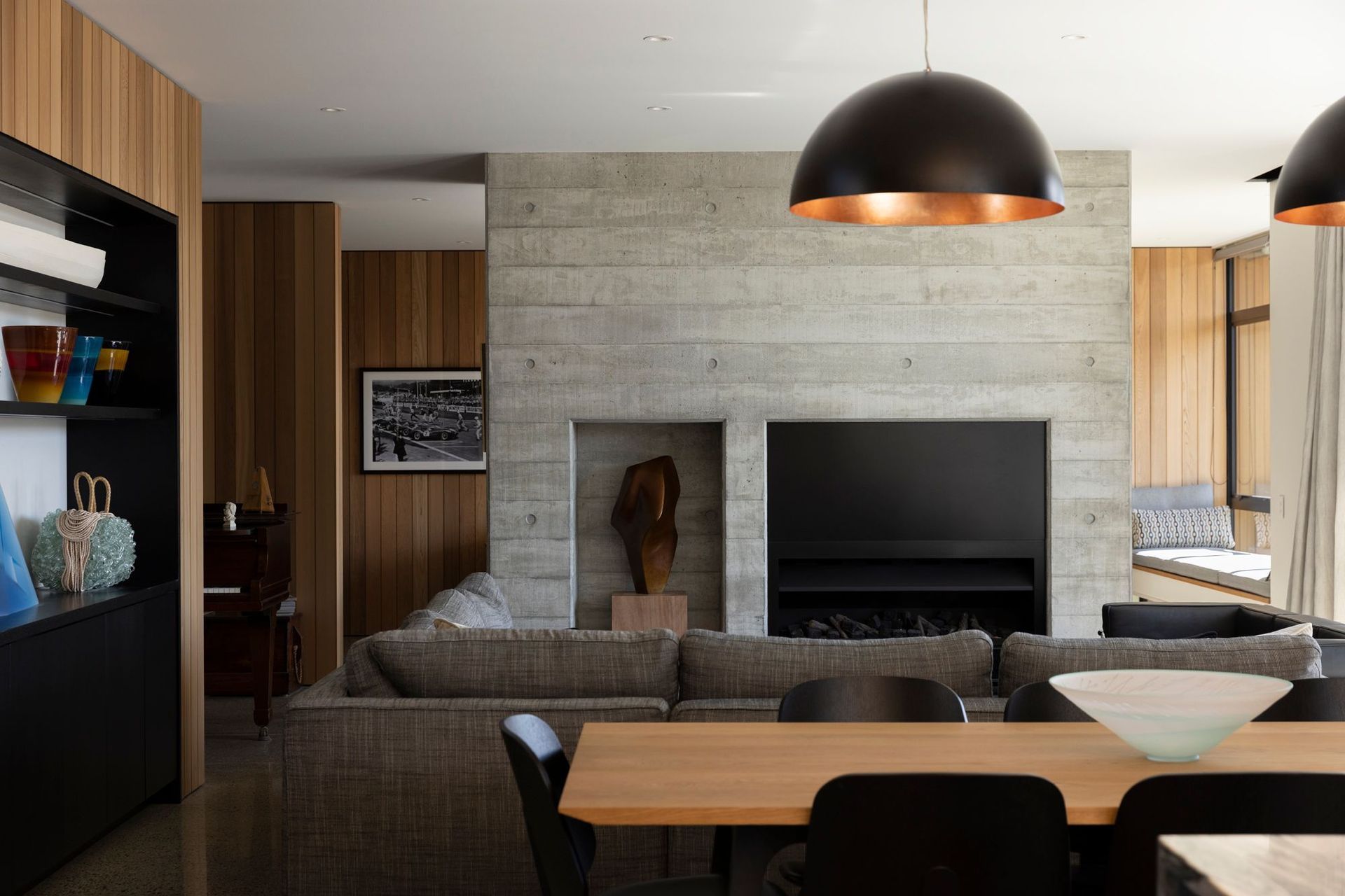 The homeowners have extensive art and ceramics collections. A niche in the formed concrete was created to display a sculptural piece. Real Fires fireplaces face both the living area and the den.