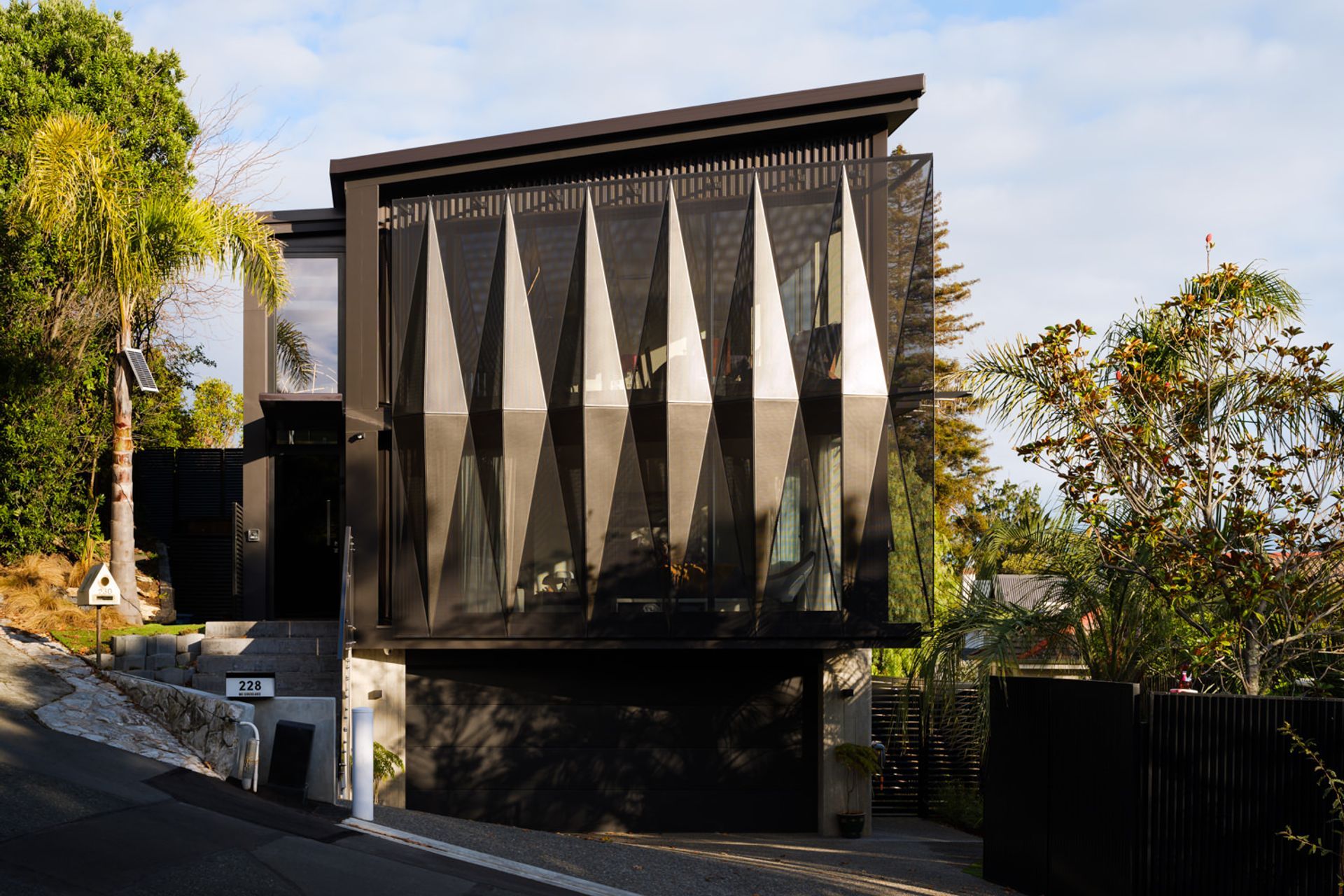 Situated over three levels, this house maximises its 331m2 site as well as the views out across the city towards Port Nelson and Te Tai-o-Aoere/Tasman Bay.