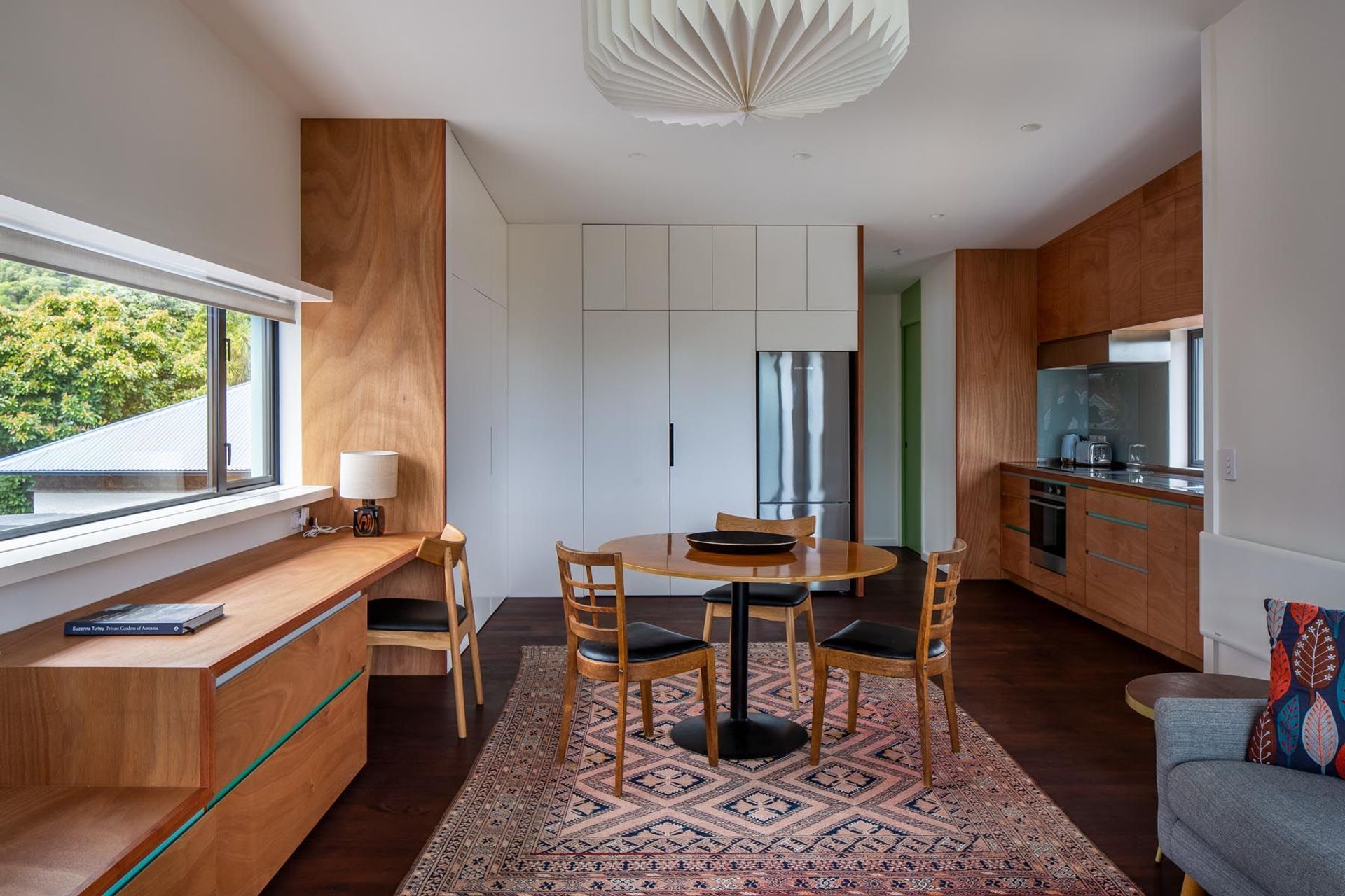 The upstairs one-bedroom apartment shares its design style with the main house. There are glimpses of sea view from the kitchen sink.