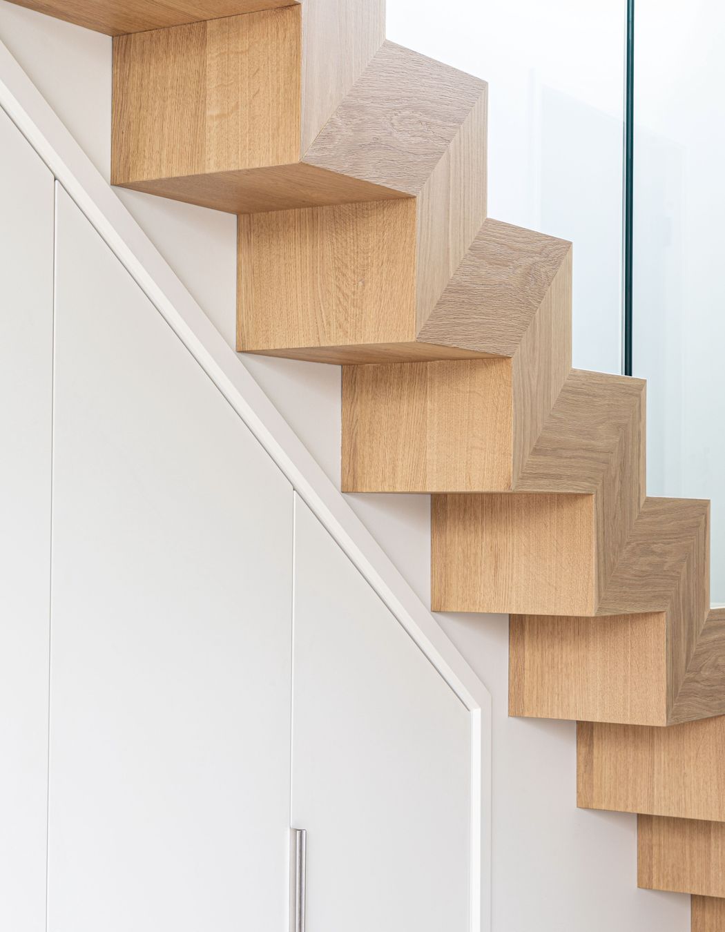 The geometric detailing of the stair has a strong sculptural quality.