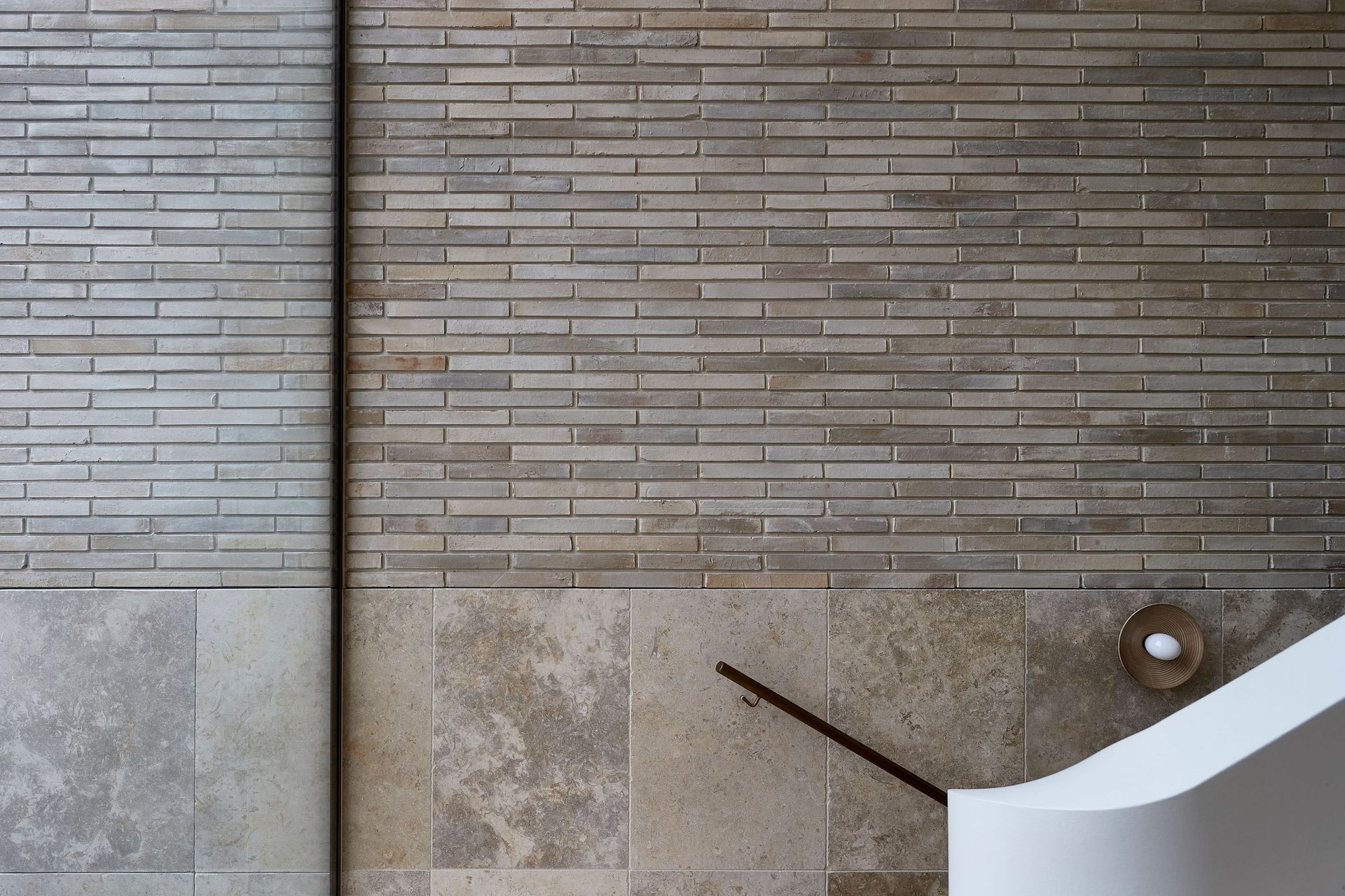 The central staircase showcases the key materials working in perfect harmony.