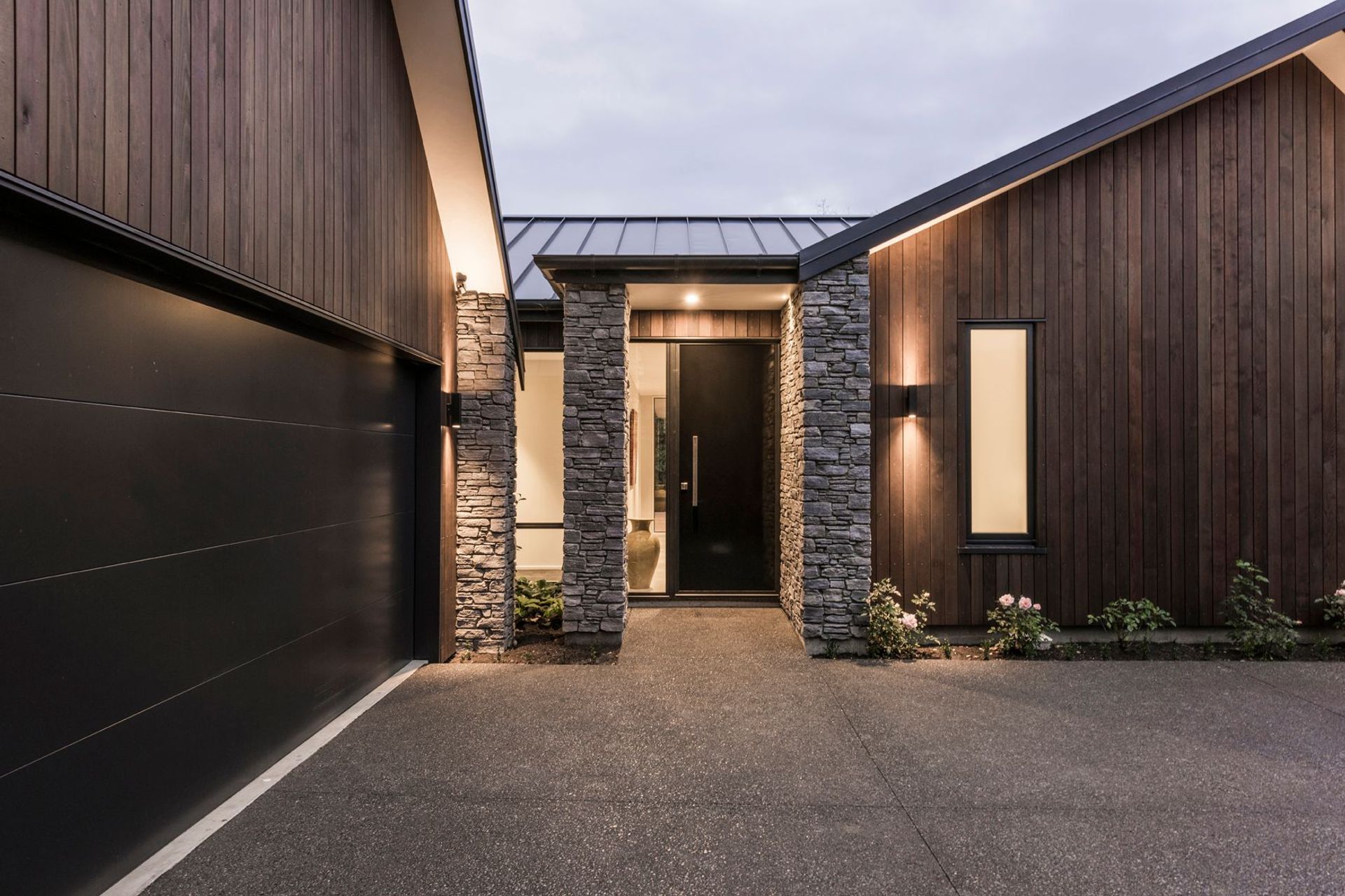 The client requested a luxury material palette including stone, cedar and tray profile roofing.