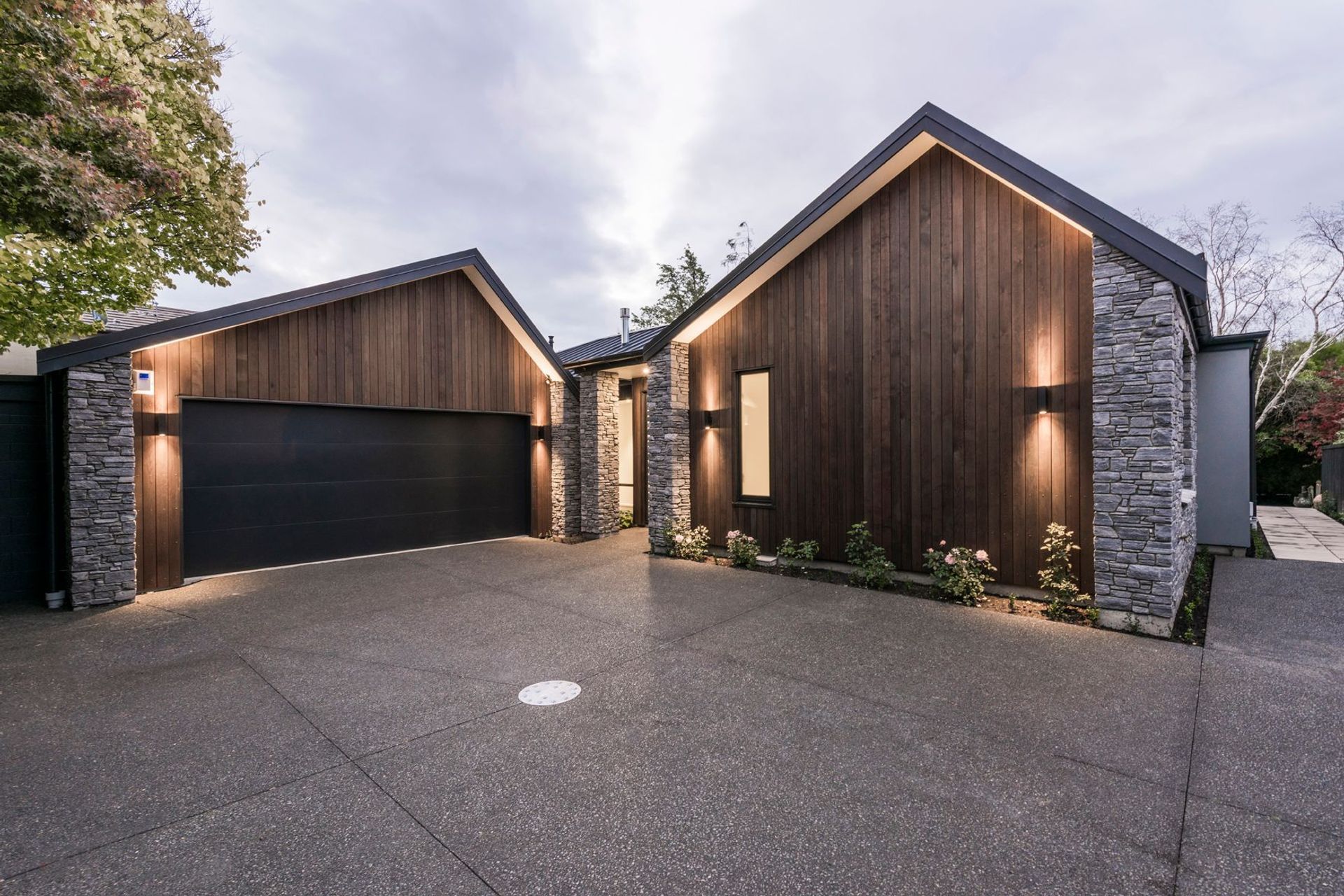 The face of the home seen in the forecourt, belies the idyllic stream setting.