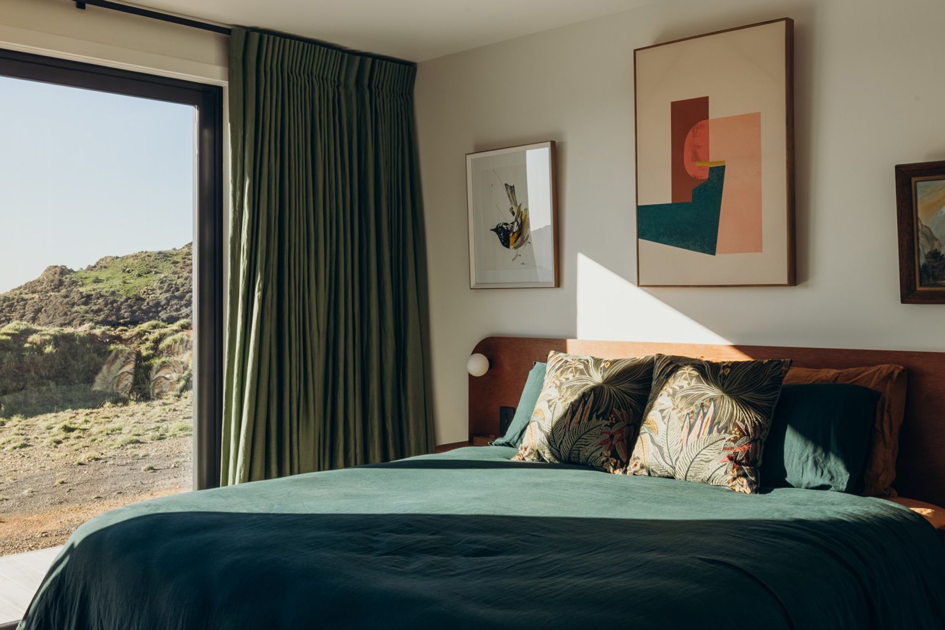 The Master Bedroom, with views over the Cook Strait, boasts a custom bed unit built by INLINE to compliment the cabinetry throughout the home.