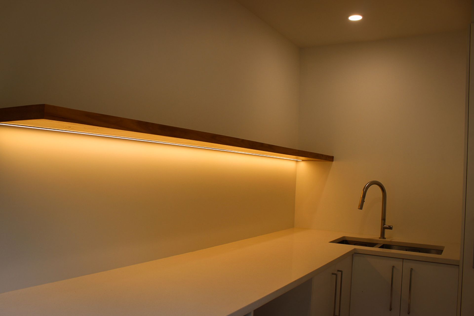 Blackbutt (Pilularis) timber custom built floating shelf give this functional laundry a high-end & luxurious feel. Inset strip LED lighting helps make this a really practical work area.