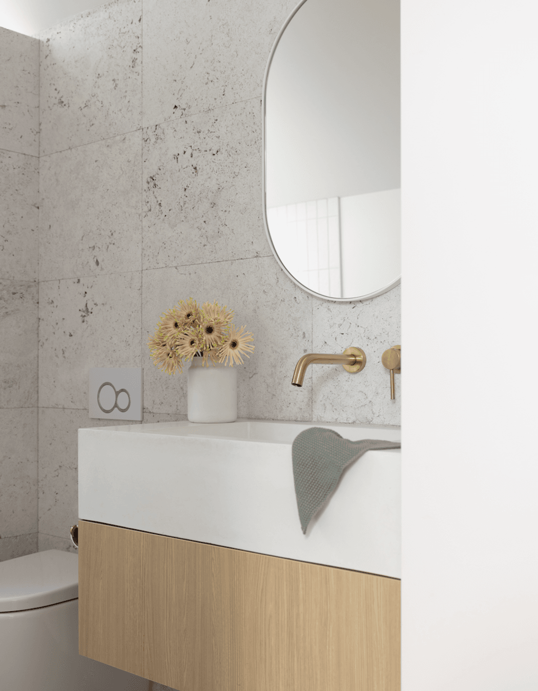 Silver travertine tiles from Artedomus and RAW Concrete basin