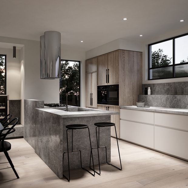 Contemporary kitchen featuring a large grey stone island with integrated sink and waterfall edge, dark minimalist bar stools, pale timber flooring, and full-height wood-grain cabinetry with built-in appliances. White lower cabinetry, a matching stone benchtop and splashback, black-framed windows, recessed ceiling lights, and a prominent cylindrical metal rangehood complete the refined open-plan space.