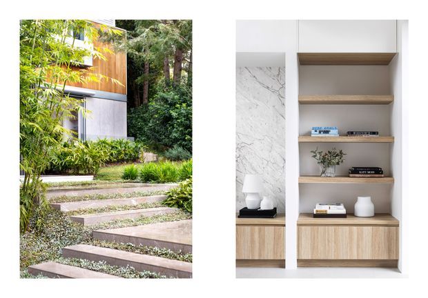 A split image showing a landscaped exterior walkway beside a contemporary home and a built-in interior shelving unit. The exterior features broad floating concrete or stone steps, dense bamboo and woodland planting, and a facade combining warm timber cladding with pale smooth panels. The interior shows white built-in joinery with open timber shelves, light timber cabinetry, and a marble-look vertical feature panel, styled with books and minimal decor.