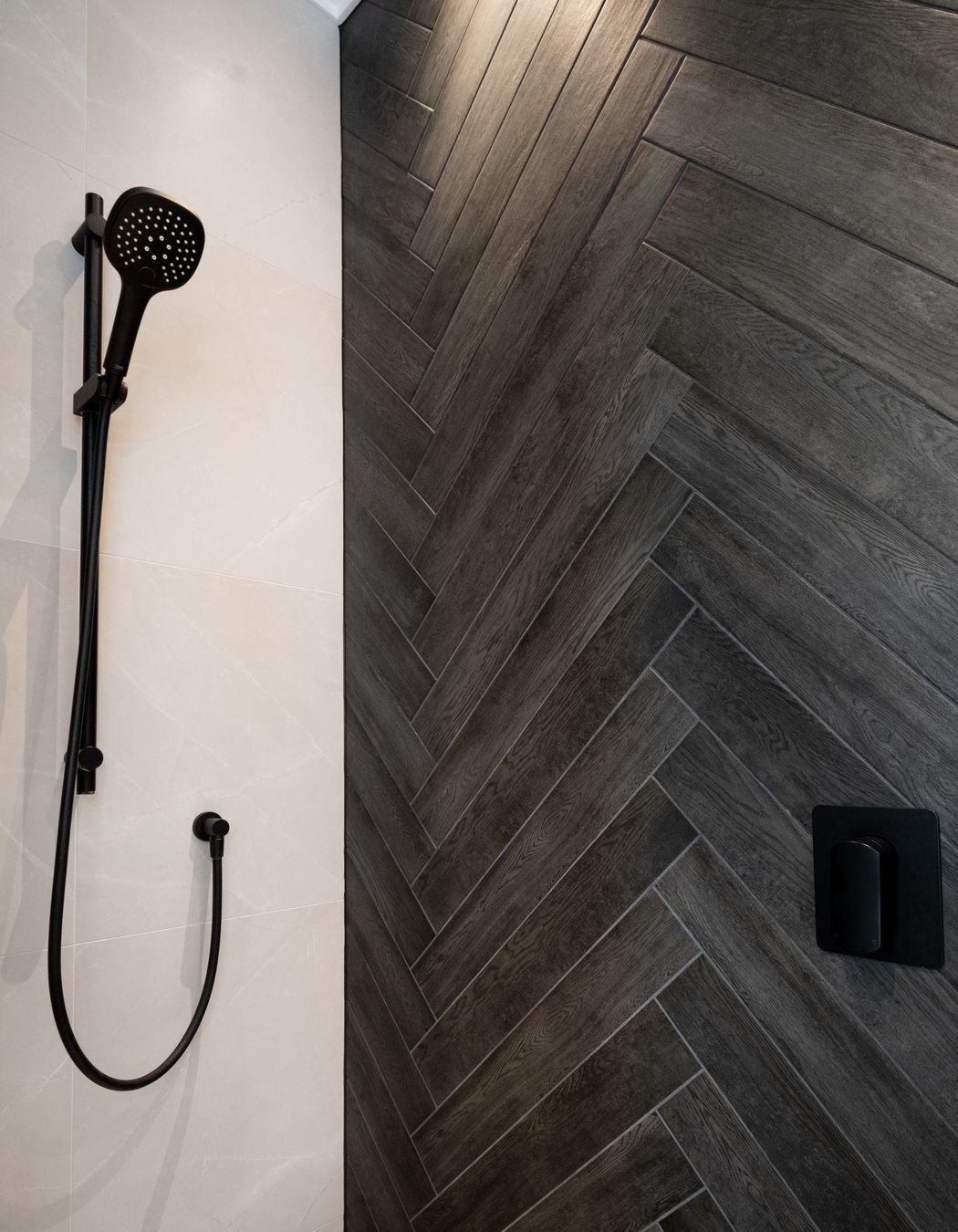 Granite herringbone tiles are echoed from the kitchen to the bathroom.