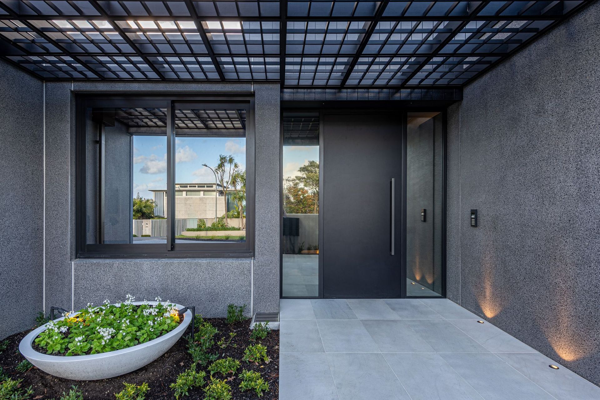 The clients wanted a black house, so the materials needed to be able to handle that. They also needed to be durable due to the proximity to the beach. For that reason concrete and Accoya were chosen and teamed with black joinery.