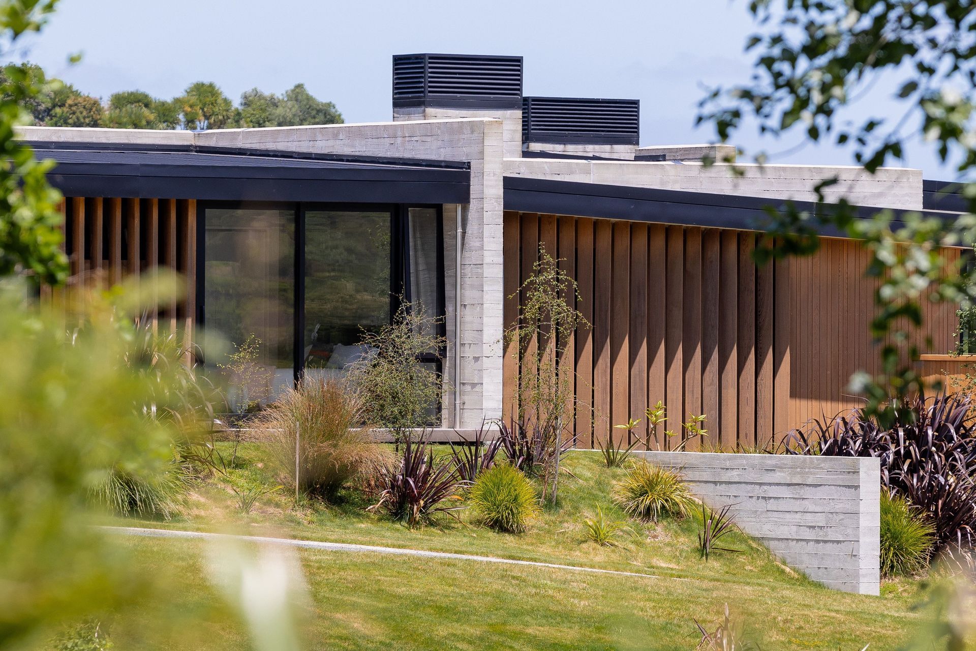 Insitu-concrete walls are broken with cedar fins and vertical cedar cladding.