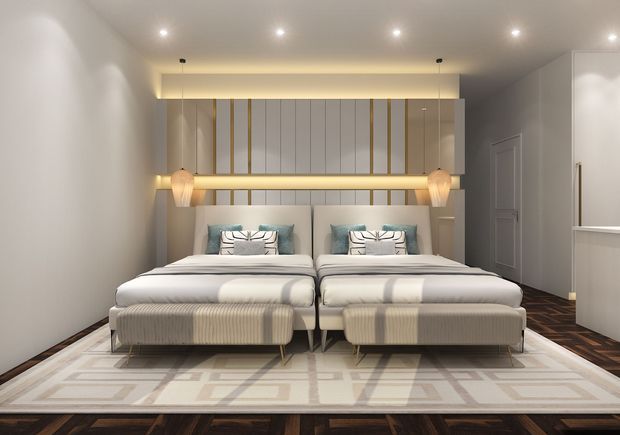 Contemporary twin bedroom with two upholstered beds, a shared illuminated timber-and-gold feature wall, integrated pendant lighting, dark timber flooring, and a large geometric area rug. Neutral beige, cream and grey tones create a refined, softly lit hotel-like atmosphere.